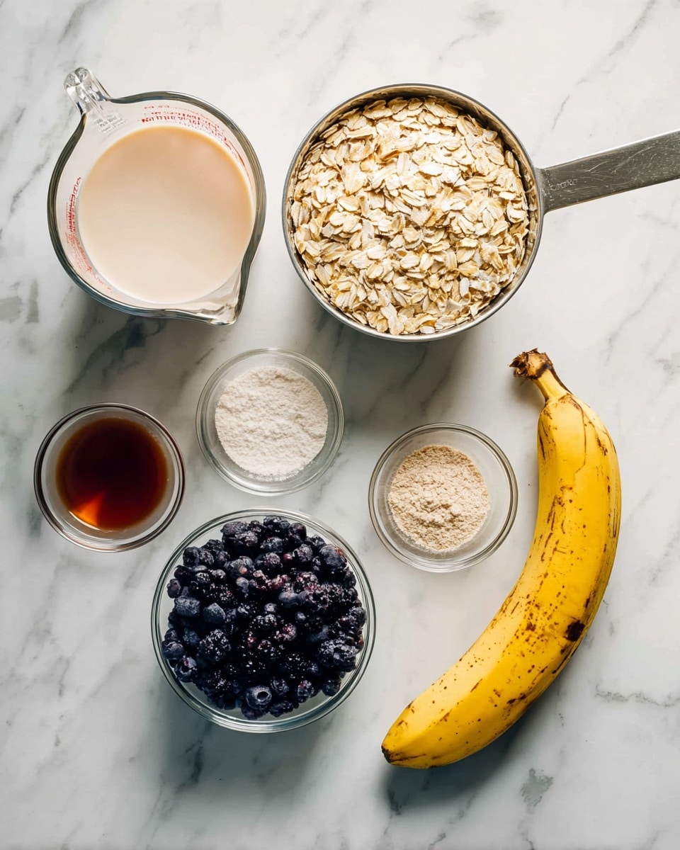 The image shows ingredients arranged on a white marbled surface: a clear measuring cup filled with a light cream-colored liquid on the left, a metal measuring cup filled with light brown rolled oats at the top right, and a metal measuring cup filled with dark purple blueberries at the bottom right. Near the center is a whole yellow banana with some brown spots. There are also three small clear glass bowls, each holding a different powder or liquid: one with white powder, one with a light beige powder, and one with a brownish-red liquid. photo taken with an iphone --ar 4:5 --v 7