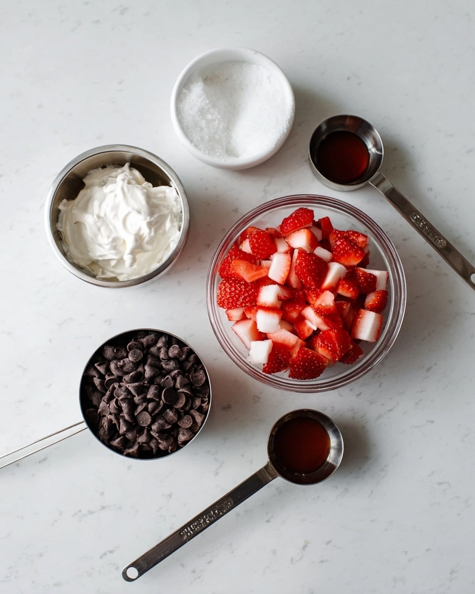 The image shows five small containers on a white marbled surface: a clear glass bowl filled with bright red and white chopped strawberries positioned in the center, a shiny metal measuring cup full of small dark chocolate chips placed in front and slightly to the right, a metal measuring cup with white creamy substance to the left, a white bowl with a scoop of solid white coconut oil placed behind the strawberries, and two metal measuring spoons holding dark brown liquid, one lying near the chocolate chips and the other closer to the bowl of coconut oil. photo taken with an iphone --ar 4:5 --v 7