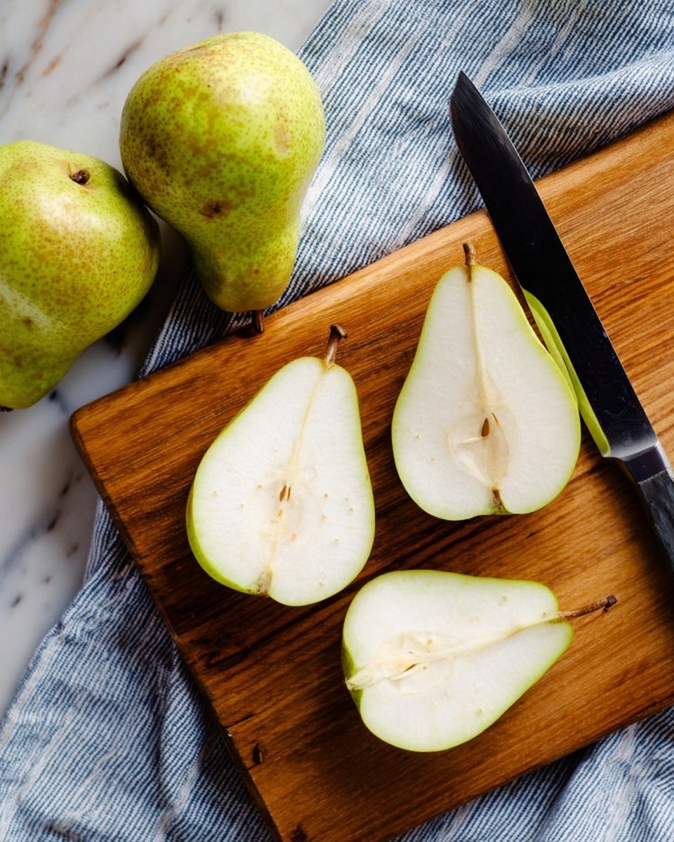 A wooden cutting board with a few slices of light green pear on it. There are three pear slices showing white and smooth flesh with a few seeds inside. Two whole pears with green and brown skin sit on a blue and white striped cloth beside the cutting board. A dark-handled knife with a black blade rests on the board near the pear slices. The whole setting is on a white marbled surface. photo taken with an iphone --ar 4:5 --v 7