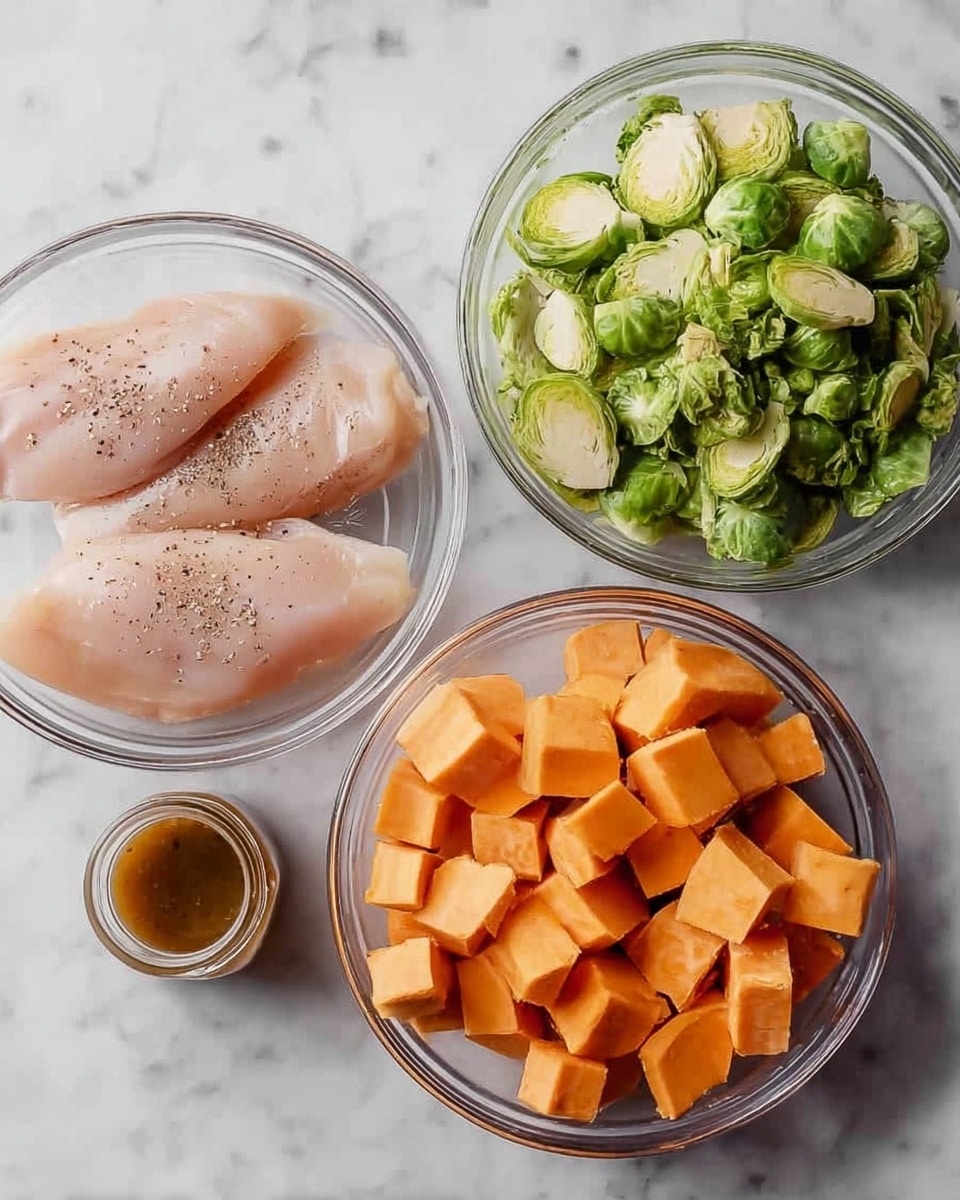 The image shows four clear glass bowls on a white marbled surface. The top-left bowl contains three raw chicken fillets seasoned with black pepper, pale pink in color with a smooth texture. The top-right bowl is filled with chopped green brussels sprouts, each piece showing the layered leaf texture. The bottom-right bowl holds cubed orange sweet potatoes with sharp edges and a firm texture. In the center, there is a small jar filled with brown sauce or dressing. The arrangement is neat and clean. Photo taken with an iphone --ar 4:5 --v 7