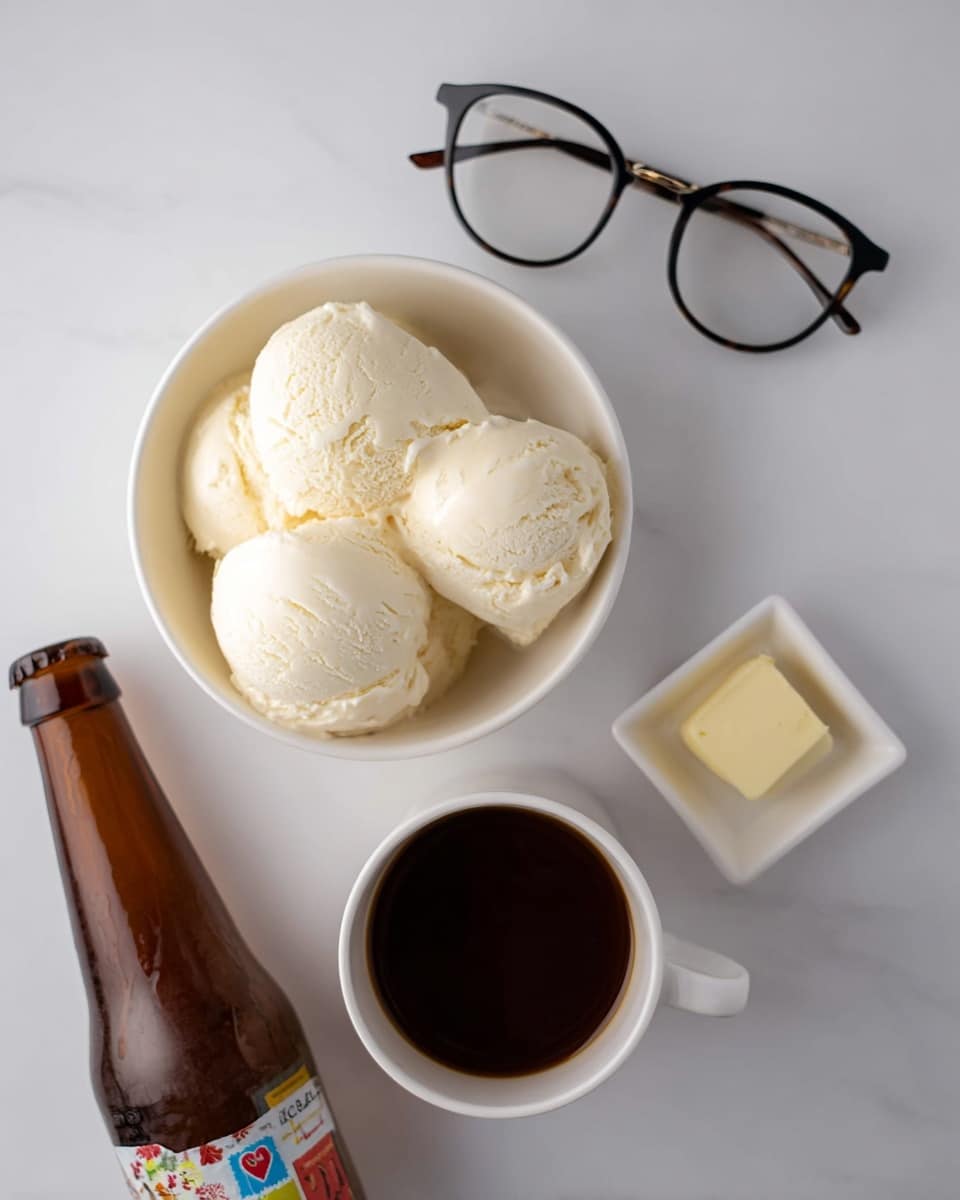 The image shows a white bowl filled with four large scoops of creamy white vanilla ice cream. Next to the bowl, there is a small white square dish with a small piece of pale yellow butter. Below that, a white cup is filled with smooth dark brown coffee or chocolate liquid. To the left, there is a brown glass bottle lying on its side with a colorful label visible. Above all these, a pair of black round eyeglasses rests on a clean white marbled surface. The photo is taken with an iphone --ar 4:5 --v 7