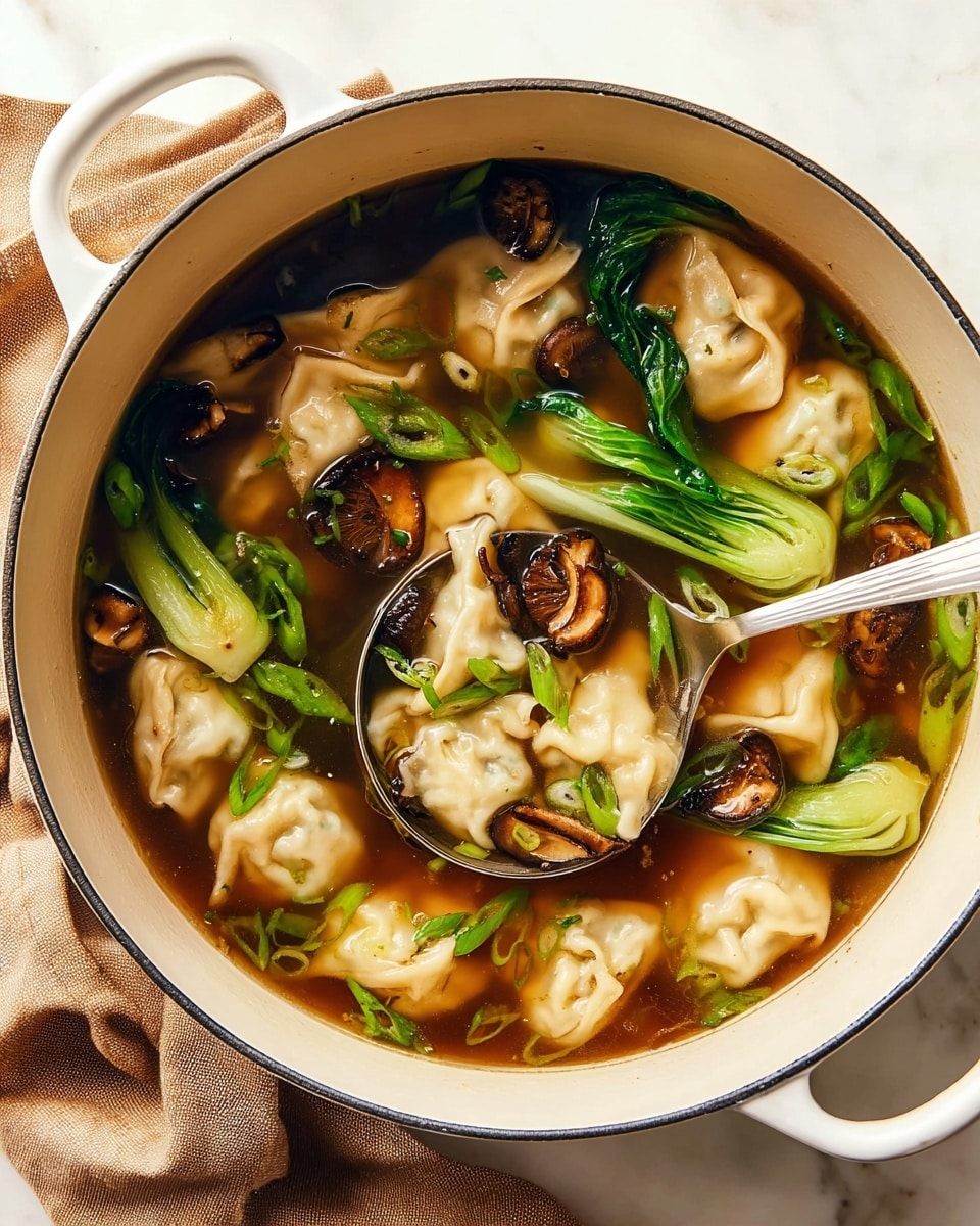 A white pot filled with clear brown broth, floating with light beige dumplings that have soft, crinkled edges. Bright green bok choy leaves and lens-shaped shiitake mushroom slices with dark brown caps add texture and color throughout the soup. Scattered thin green onion slices bring small pops of bright green on the top. A silver ladle is resting inside, partially submerged, lifting some bok choy and dumplings. The pot sits on a white marbled surface with a soft brown cloth nearby. Photo taken with an iphone --ar 4:5 --v 7