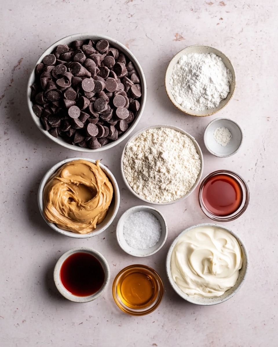 The image shows several small white bowls arranged on a white marbled surface, each holding different ingredients. The largest bowl is filled with dark brown chocolate chips piled high. Surrounding it are smaller bowls containing light beige powder, creamy peanut butter with a smooth texture, white flour, thick white yogurt or cream, salt crystals, a small amount of amber liquid, clear water, and a dark red syrup or sauce. The bowls are all neatly placed, showcasing a variety of textures and soft colors against the light background. Photo taken with an iphone --ar 4:5 --v 7