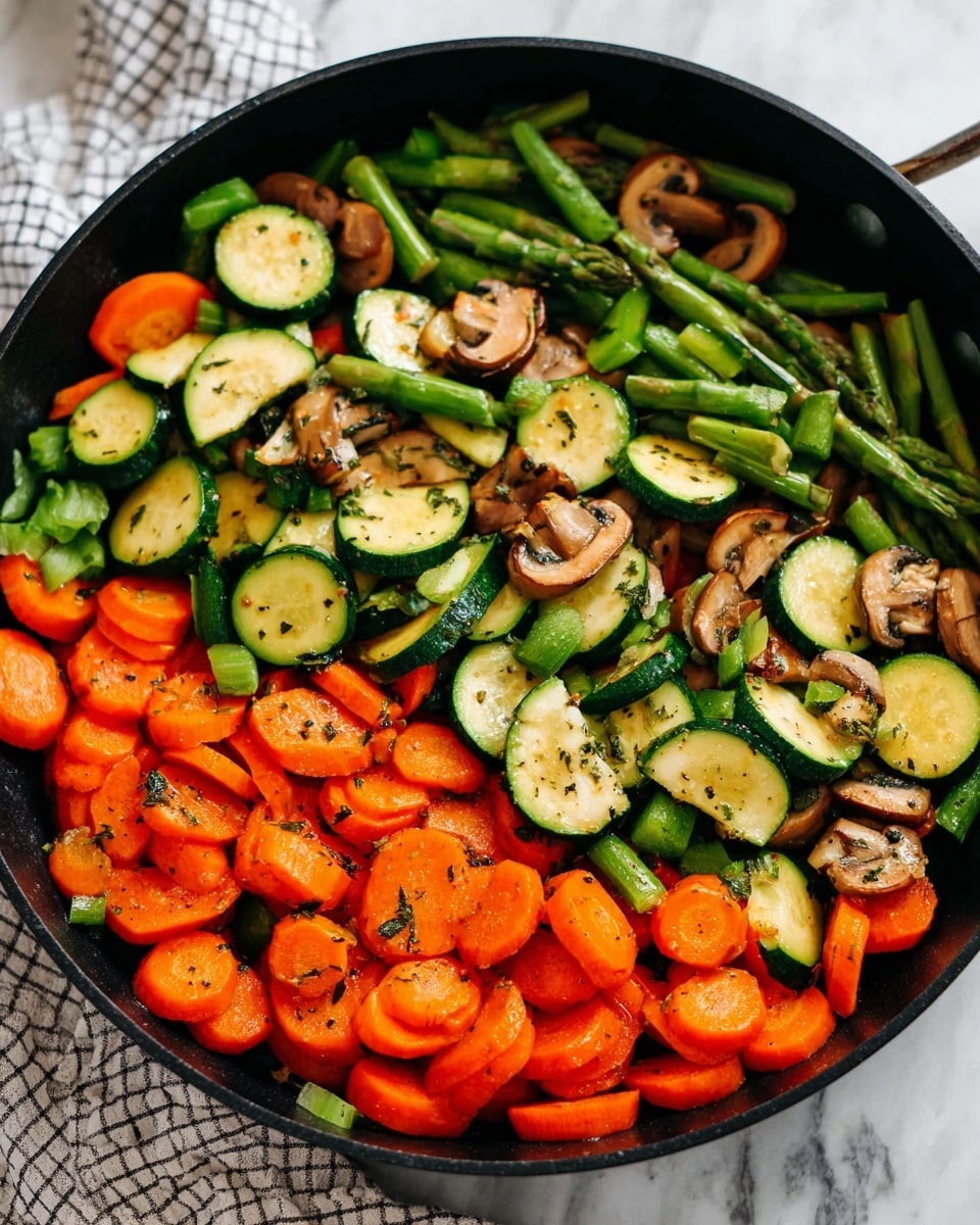 The image shows a pan filled with a colorful mix of cooked vegetables. There are three main layers: the bottom layer is sliced carrots in bright orange round shapes, the middle layer consists of chopped green asparagus pieces, and the top layer has half-moon shaped zucchini slices with light green flesh and dark green skin, along with small mushroom pieces scattered evenly. The vegetables are lightly seasoned with black pepper and herbs, giving a natural, glossy finish. The pan is black with a simple design, placed on a surface with a white marbled texture and a checkered cloth partially visible at the bottom. Photo taken with an iphone --ar 4:5 --v 7