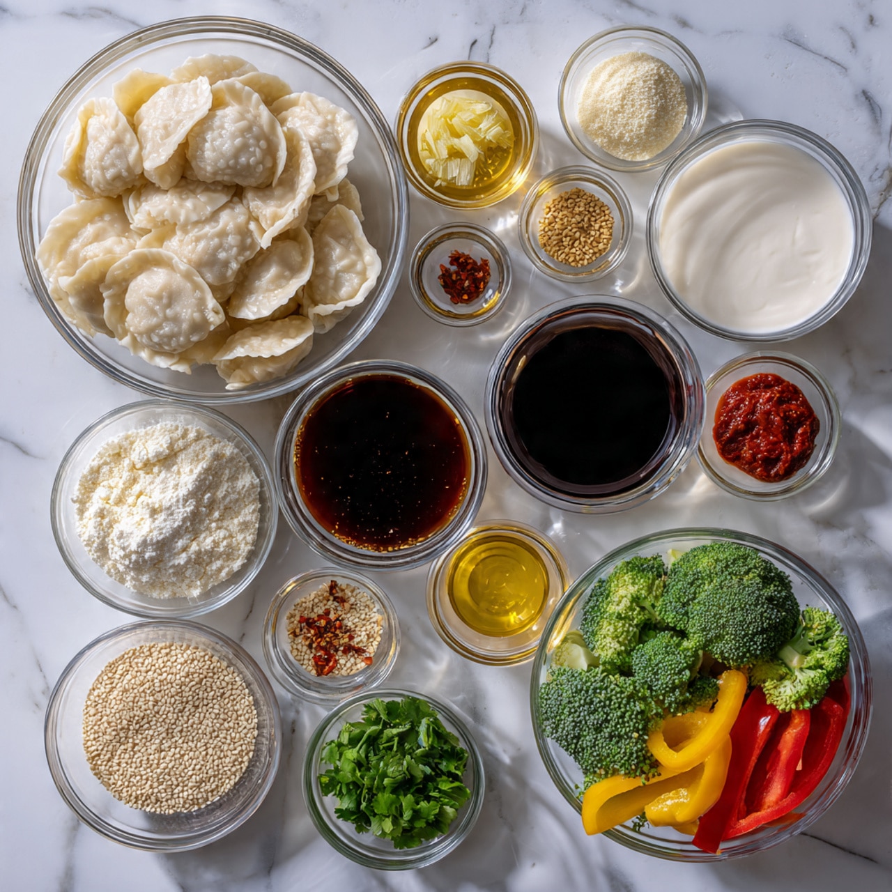 The image shows a white marbled surface with 13 clear glass bowls arranged neatly, each containing different ingredients. On the left, a large bowl filled with pale yellow frozen potstickers sits beside smaller bowls with dark amber sesame oil, finely chopped light yellow ginger, and white sugar. Moving to the center, there is a bowl with dark brown soy sauce, a small bowl with bright red curry paste, a large bowl of creamy white coconut milk, and a clear bowl holding light yellow minced garlic. On the right side, a large bowl contains colorful fresh vegetables including green broccoli florets and red bell peppers, surrounded by small bowls filled with beige sesame seeds, finely chopped green cilantro, green onions, and red pepper flakes. The composition is clean, vibrant, and clearly shows each ingredient’s texture and color. Photo taken with an iphone --ar 4:5 --v 7
