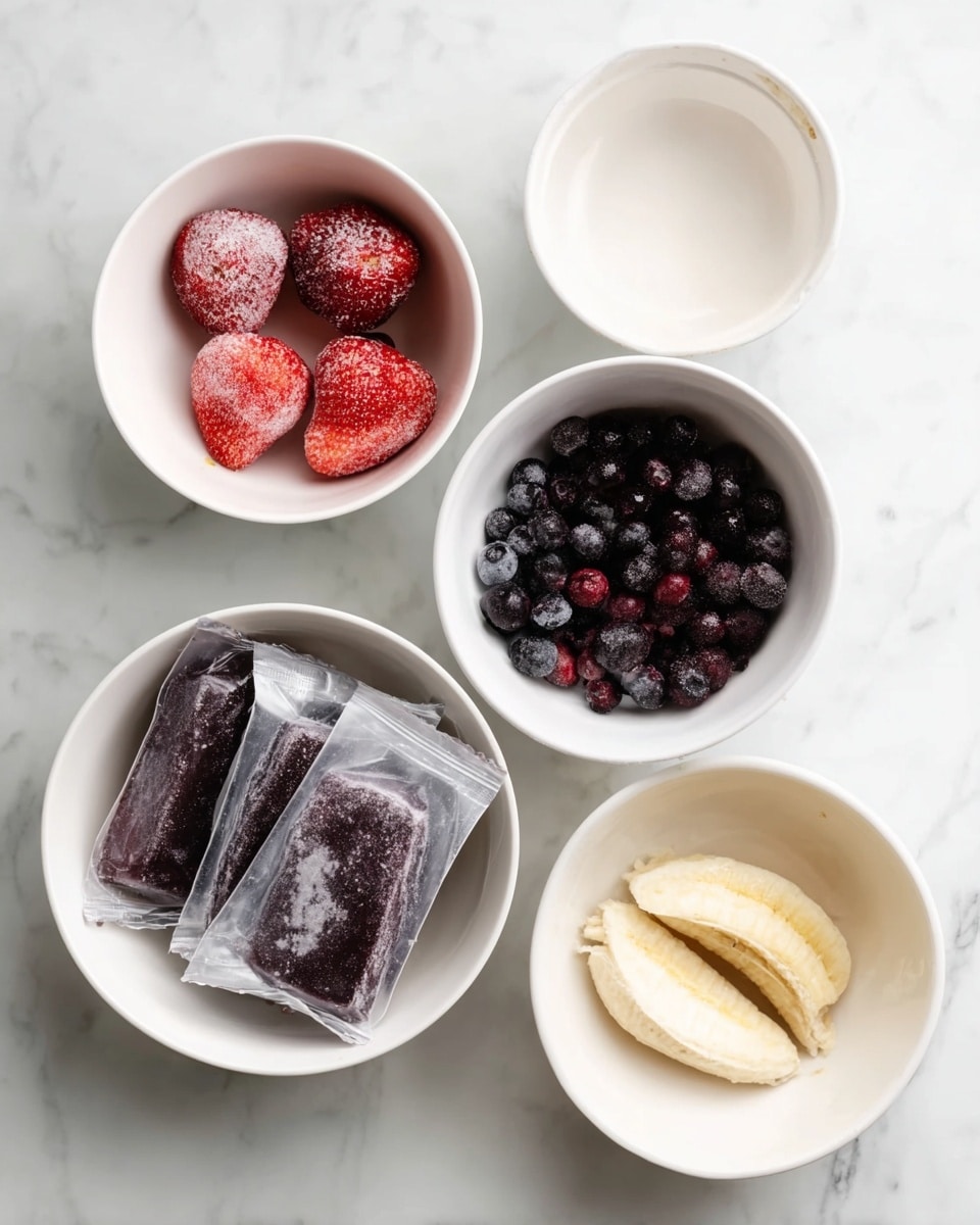Five white bowls are arranged on a white marbled surface, each containing a different ingredient. The top left bowl holds four frozen strawberries with a light frost on them, varying from bright red to deep red. The top right bowl appears empty but has a smooth creamy texture inside. The center bowl is filled with dark purple blueberries, slightly frosted. The bottom left bowl contains two vacuum-sealed packs of dark purple frozen berries, with ice crystals on the outside of the packaging. The bottom right bowl holds two frozen banana halves with a pale yellow color and some frost visible. Photo taken with an iphone --ar 4:5 --v 7