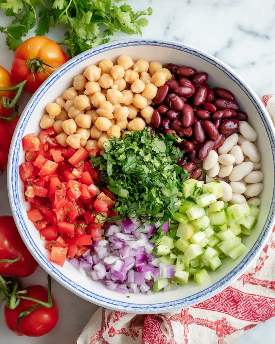 A white bowl with a blue rim holds seven distinct layers of fresh, colorful ingredients arranged in sections. At the top, light beige chickpeas sit next to dark red kidney beans on the right and pale white beans beside them. Below these, bright green chopped cilantro covers the center, surrounded by diced red tomatoes at the bottom left. Cubed light green celery is on the left of the tomatoes, and pale green cucumber pieces are on the bottom right. Finely chopped purple onions fill the top left space. The bowl sits on a white marbled surface with a red and white cloth beneath, with fresh tomatoes and greens nearby. Photo taken with an iphone --ar 4:5 --v 7