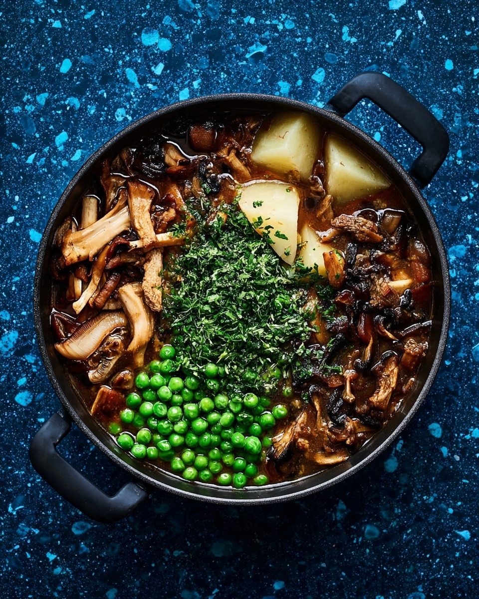 A round black pan filled with a rich stew sits on a deep blue speckled surface. The stew has three main sections: lightly browned and wilted mushroom pieces on the right with different shapes and textures, bright green peas clustered in the bottom left, and a pile of finely chopped green herbs in the center above the peas. Large pale potato chunks soften the background of the pan, partially submerged in dark brown broth that glistens with moisture. The pan has two short black handles on each side. photo taken with an iphone --ar 4:5 --v 7