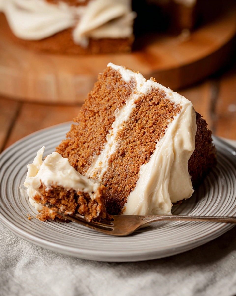 A slice of two-layer brown cake with a smooth, creamy white layer of frosting between the layers and a spread of the same frosting on the outside right side, resting on a white plate with soft grey rings. A fork holds a piece of the cake with white frosting on it, placed on the plate in front of the slice. The background surface is a white marbled texture but appears warm due to lighting, with wooden boards underneath. Photo taken with an iphone --ar 4:5 --v 7