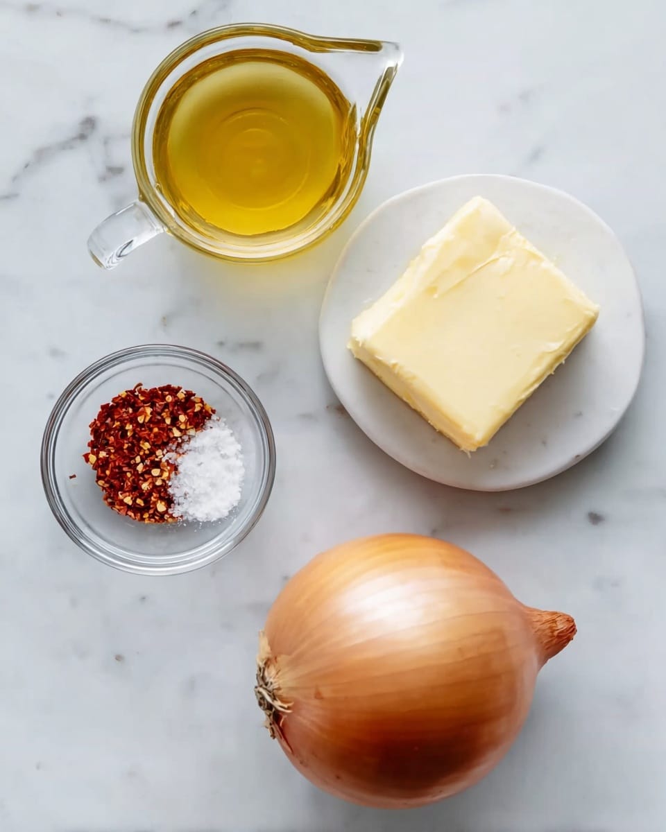 The image shows four ingredients arranged on a white marbled surface: a whole yellow onion with a smooth, shiny skin placed at the bottom right, a small glass bowl with a pale yellow solid block of butter positioned to the left of the onion, a white measuring cup filled with golden yellow olive oil near the top left, and a small clear glass bowl containing red chili flakes and white salt at the top right. The items are spaced apart and viewed from above, with soft natural lighting. Photo taken with an iphone --ar 4:5 --v 7
