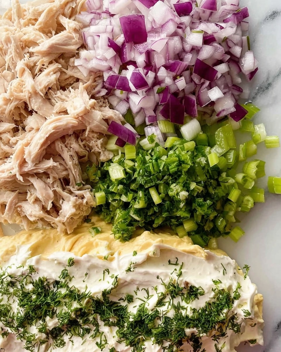 The image shows a close-up of seven layers of chopped and mixed ingredients arranged neatly on a white marbled surface. Starting from the top left, there is a light beige layer of shredded chicken. To the right of the chicken, there is a layer of finely chopped red onions with purple and white colors. Below the onions, on the right side, there is a layer of small, bright green celery pieces. Below the celery, in the center, there are two layers: a creamy, off-white mayonnaise layer with a smooth texture and fresh green chopped dill sprinkled on top. To the left of the mayonnaise and dill, there is a thick, pale yellow mustard layer. Each layer's edges touch but remain distinct, creating a clear visual separation. The photo is taken with an iphone --ar 4:5 --v 7