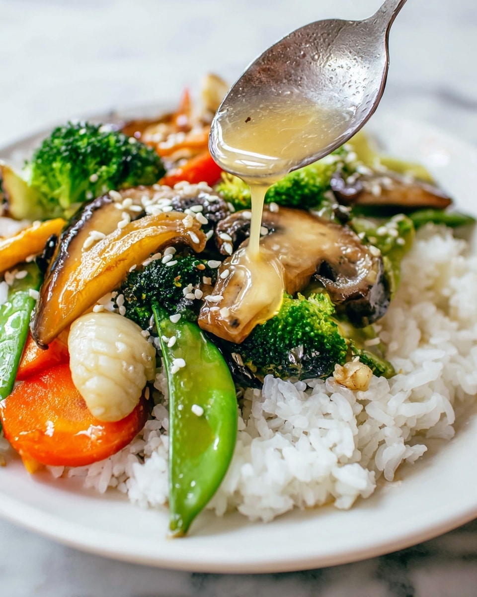 A white plate holds a serving of white rice forming the base layer, topped with various vegetables including bright green broccoli florets, orange carrot slices, and green snap peas. Large, light brown mushroom slices are spread on top, along with some beige water chestnuts. The vegetables and mushrooms are sprinkled with white sesame seeds. A silver spoon is pouring a glossy, light-colored sauce over the vegetables from the top right, with the spoon close to the plate. The plate sits on a white marbled surface. photo taken with an iphone --ar 4:5 --v 7