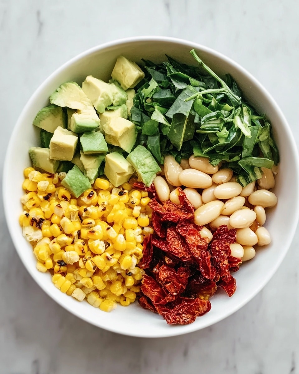 A white bowl is filled with five colorful sections of food placed side by side. Starting from the top left, there are light green chunks of avocado with a smooth texture. Next to it on the right, there are dark green chopped leafy vegetables with a fresh look. To the far right, there are pale beige beans with a smooth surface. Below the beans, there is a pile of reddish-brown sun-dried tomato pieces with a slightly wrinkled texture. At the bottom left, bright yellow grilled corn kernels with small char marks are arranged closely together. The bowl is set on a white marbled surface. Photo taken with an iphone --ar 4:5 --v 7