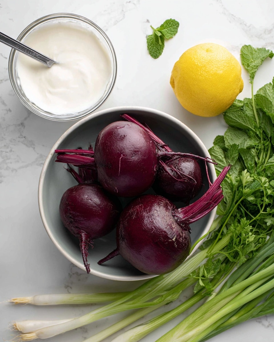 A close-up view of four whole raw beets with deep purple skin and attached stems arranged in a white bowl at the center, surrounded by a halved yellow lemon on the top right next to fresh green parsley and mint leaves, with white green onions extending from the bottom left corner toward the bowl. Above the bowl is a clear container with smooth, white creamy sauce and a silver spoon resting inside. The scene is set on a white marbled surface. photo taken with an iphone --ar 4:5 --v 7