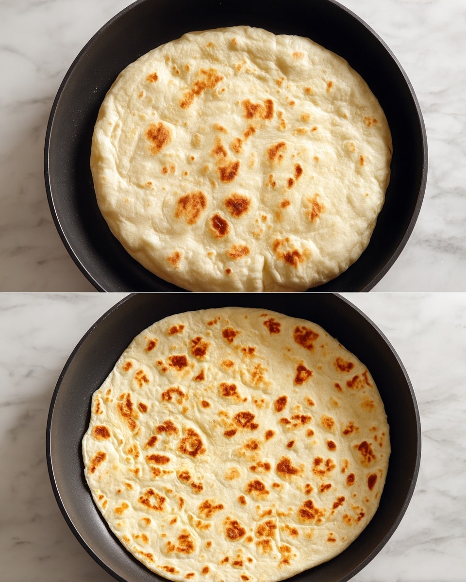 The image shows two stages of cooking a round flatbread in a black pan. The top part displays the dough puffed up, pale cream in color with a smooth, slightly wrinkled surface and rounded edges. The bottom part shows the same flatbread after cooking, now flat with light golden-brown spots scattered unevenly across its creamy white surface, and soft edges. The background is a white marbled texture. photo taken with an iphone --ar 4:5 --v 7
