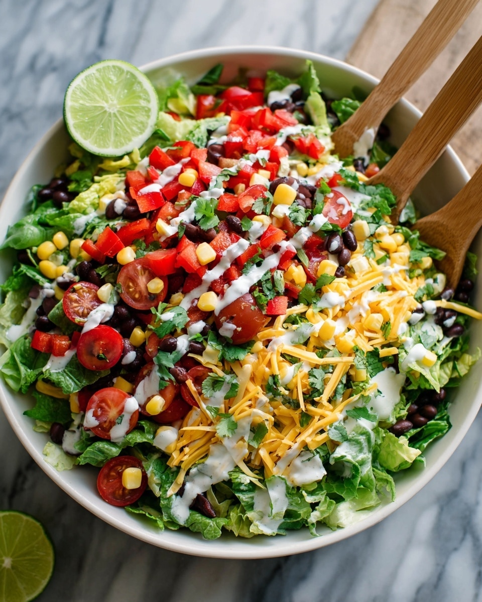 A large white bowl filled with multiple layers of fresh salad items sits on a white marbled surface. The base layer is dark green leafy lettuce torn into pieces, mixed with chopped red bell pepper. On top of this are whole and halved bright red cherry tomatoes, scattered black beans, yellow corn kernels, and shredded yellow cheese spread evenly. White creamy dressing is drizzled over the salad, spotting the ingredients gently. A round slice of lime rests on the edge inside the bowl. Two light wooden salad forks are placed vertically in the salad, ready to serve. Photo taken with an iphone --ar 4:5 --v 7