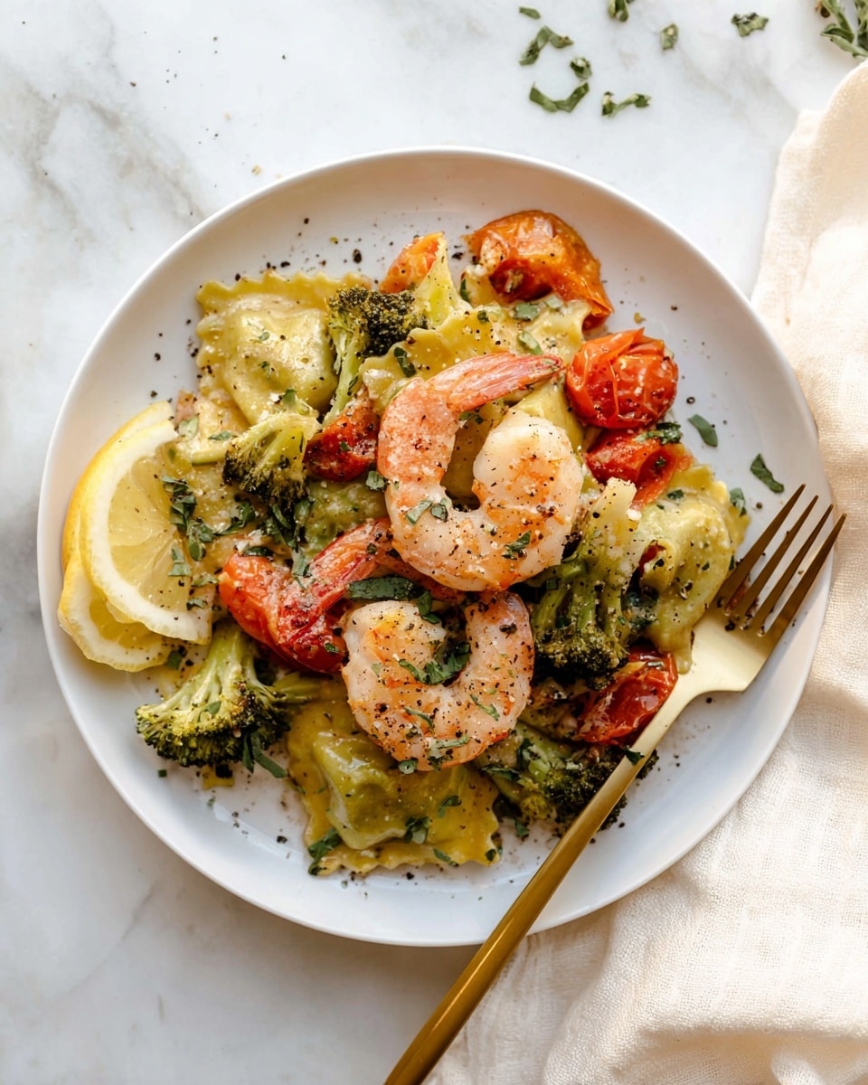 The dish shows a white plate with three layers of food. The bottom layer has green and orange ravioli with a rough texture, mixed with small pieces of broccoli and halved cherry tomatoes that are bright red and shiny. The middle layer has three cooked shrimp with a light pink color and a smooth texture, placed on top of and around the ravioli. The top layer includes fresh green herbs sprinkled over the shrimp and pasta, and there are two lemon slices placed on the side of the plate. Black pepper is sprinkled all over the food, adding small dark dots for contrast. A gold fork rests on the right side of the plate, and the whole scene is set on a white marbled surface with a soft cream cloth in the top right corner. Photo taken with an iphone --ar 4:5 --v 7
