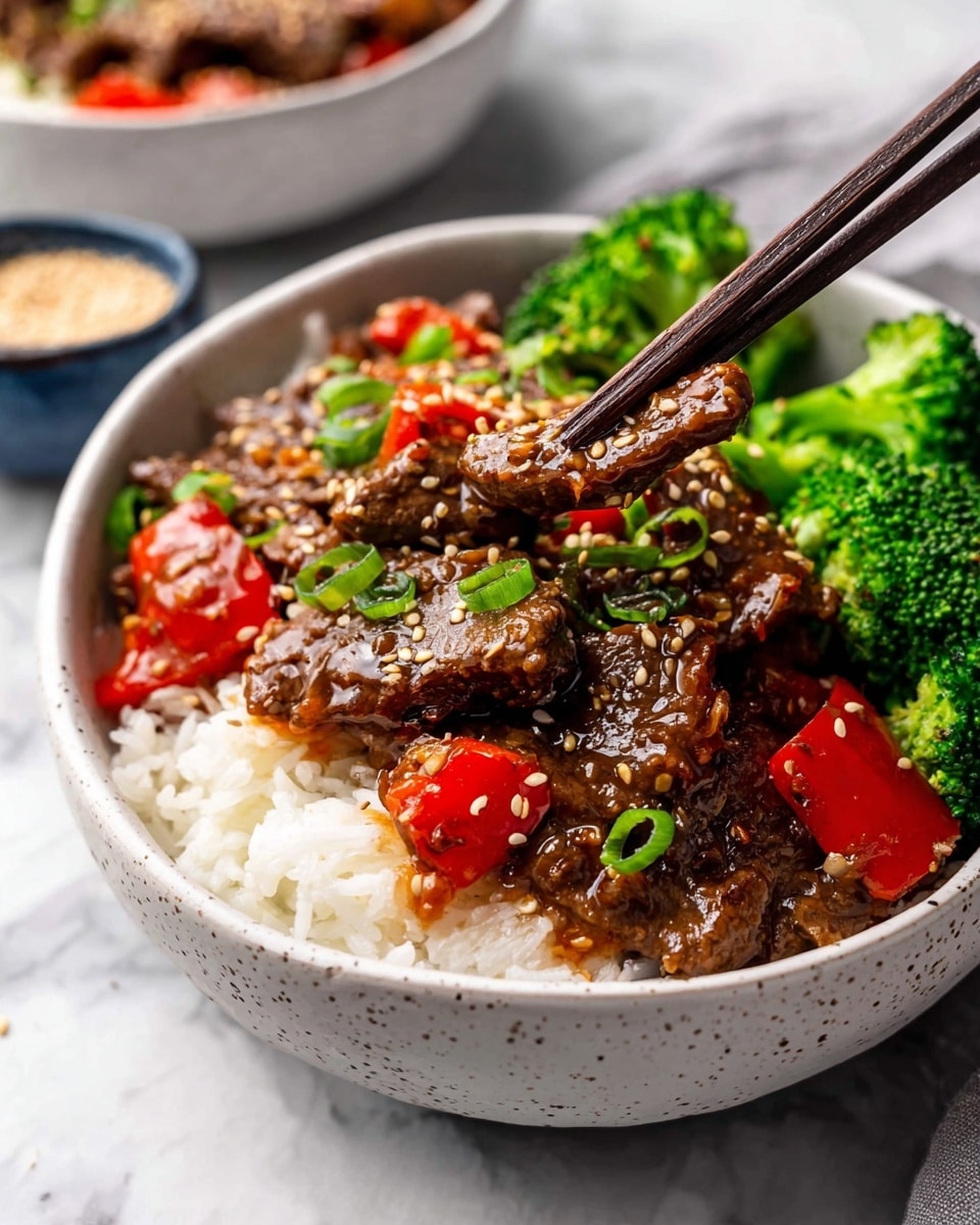 In the white speckled bowl, there are three layers: at the bottom is a bed of white rice with a soft, fluffy texture; on top of the rice are glossy, dark brown strips of beef covered in sesame seeds and small pieces of bright green onions; scattered among the beef are red bell pepper chunks adding a pop of color; on one side of the bowl, fresh, bright green broccoli florets sit neatly; dark brown chopsticks hold one beef strip above the bowl; the background shows a white marbled surface with a small blue bowl holding sesame seeds and part of another bowl with more beef and red peppers, all under soft natural light, photo taken with an iphone --ar 4:5 --v 7