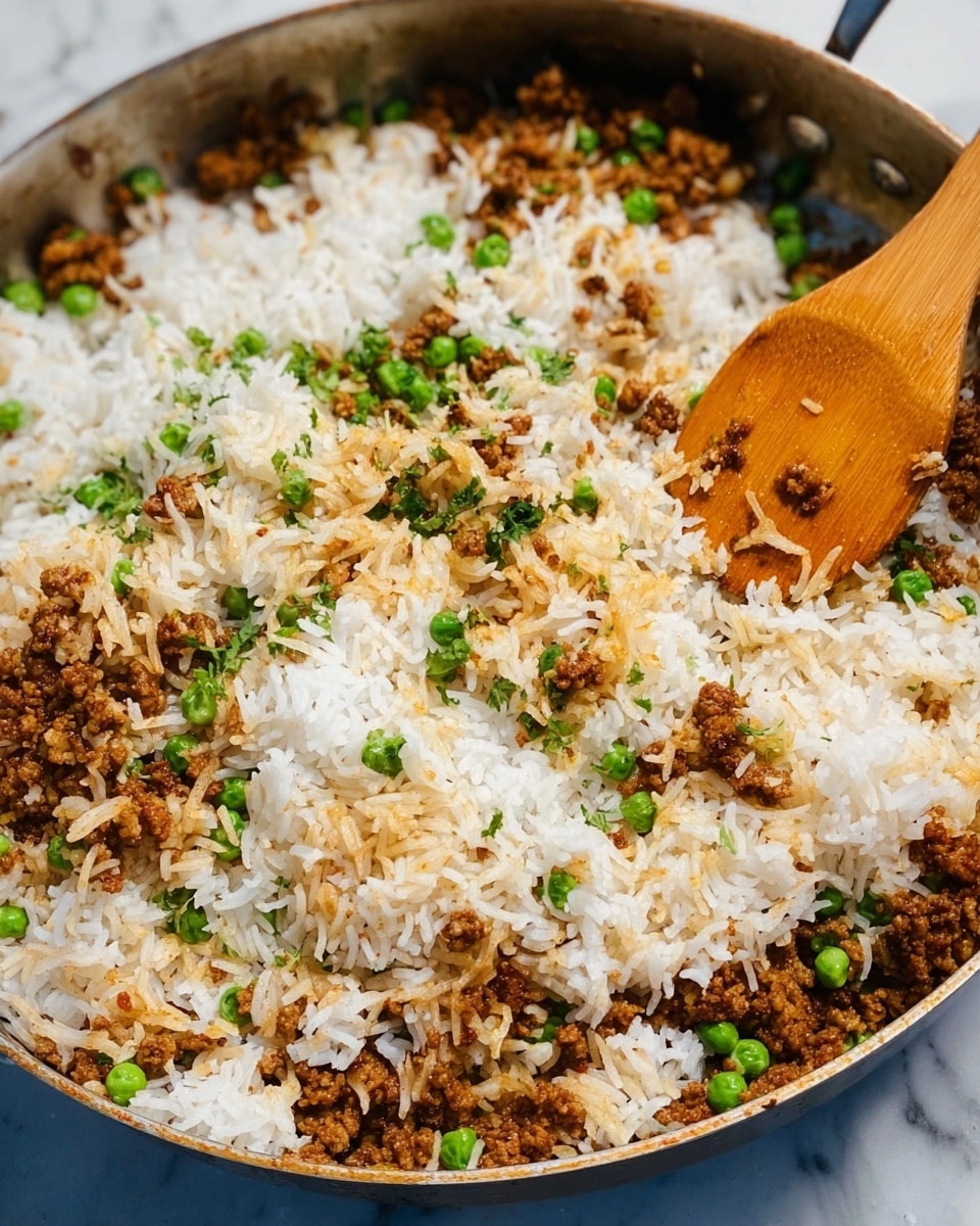 The image shows a close-up of a pan filled with a mix of white rice, some brown cooked minced meat, and green peas scattered throughout. The layers show fluffy white rice grains as the base, with browned minced meat mixed unevenly on top, adding texture and darker color patches. Small bright green peas are spread inside the mix, adding spots of color. A wooden spoon is stirring the food in the center of the pan. The background is a white marbled surface. Photo taken with an iphone --ar 4:5 --v 7