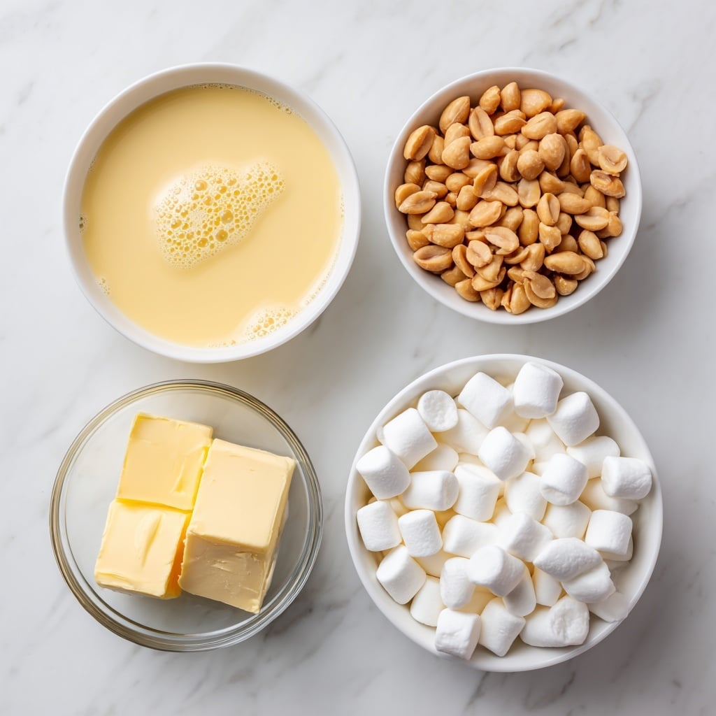 The image shows four white bowls on a white marbled surface, each filled with different ingredients. The largest bowl at the bottom holds many small, soft, white mini marshmallows. To the left and slightly above it is a smaller bowl filled with a pale yellow liquid, sweetened condensed milk, with small bubbles on the surface. To the right of that is a bowl filled with smooth, light tan peanut butter chips shaped like small discs. Above this is another bowl full of golden brown dry roasted peanuts. To the left of all the bowls is a small clear glass bowl containing two blocks of pale yellow butter. The photo taken with an iphone --ar 4:5 --v 7