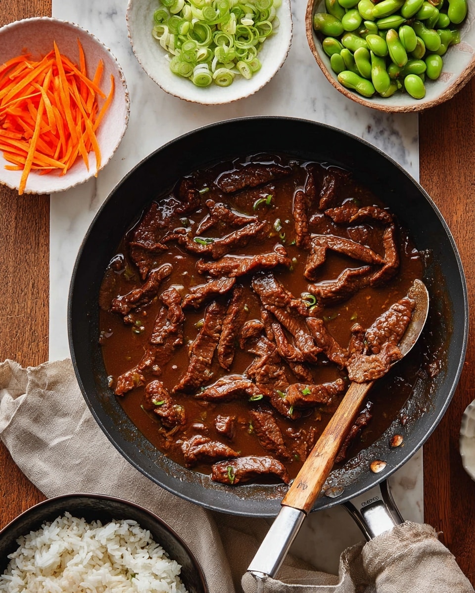 A black frying pan filled with dark brown meat strips in a thick sauce, with a spoon that has a wooden handle resting inside the pan on the right side. Around the pan are three small white bowls: one with thin orange carrot sticks at the top left, another with green sliced scallions at the top center, and a third with green edamame beans at the top right. At the bottom of the image, a black bowl contains white rice on a beige cloth, all placed on a white marbled surface. photo taken with an iphone --ar 4:5 --v 7