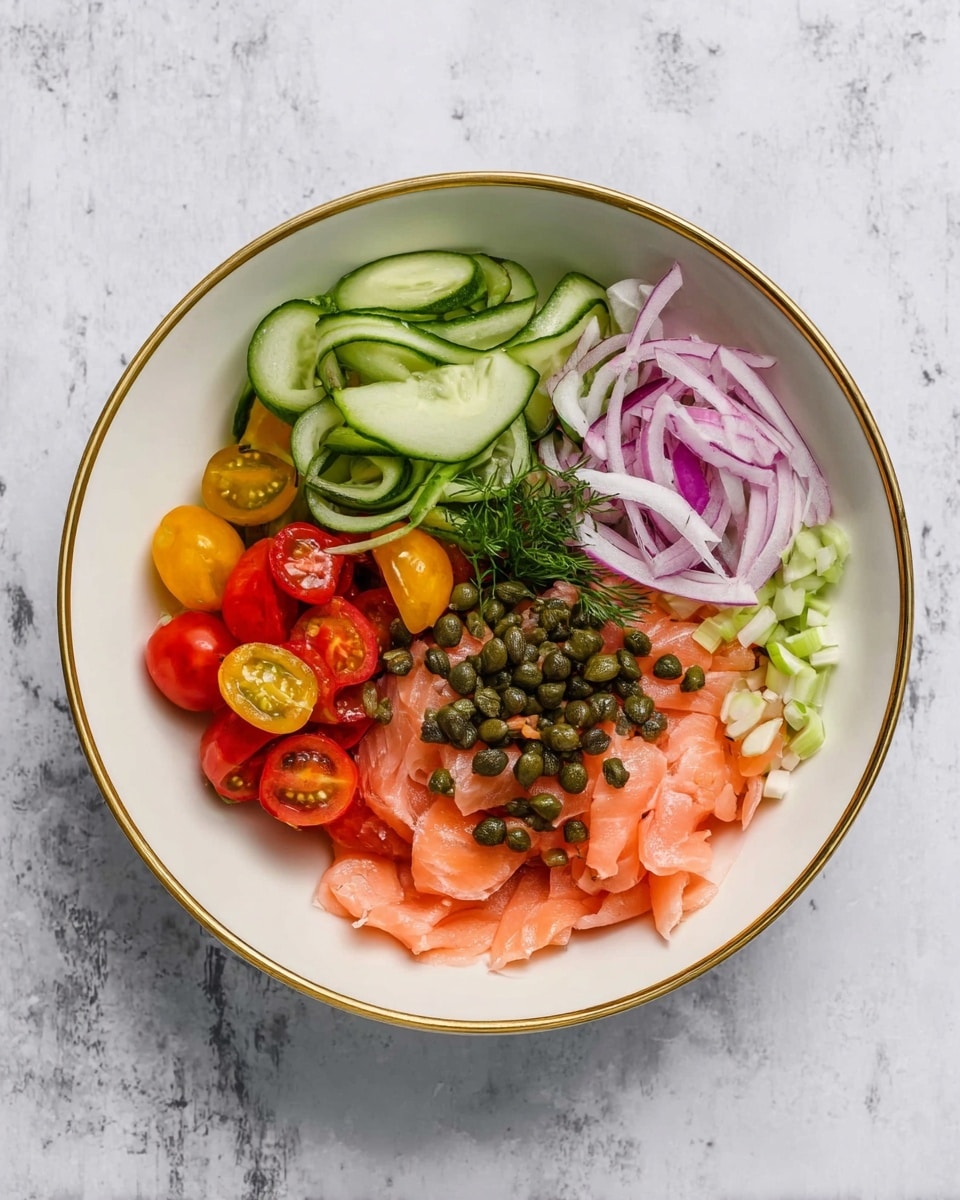 A white bowl with a gold-rimmed edge holds a fresh salad arranged in separate sections. On the left side, thin, long slices of green cucumber form a neat stack. Next to the cucumber are small cherry tomatoes in red and a few yellow, some cut in half showing their juicy inside. Thinly sliced purple onions sit near the top right of the bowl alongside a small pile of shredded light green celery. On the right side, soft, thin slices of light pink smoked salmon are arranged in a loose pile. Dark green capers are scattered over the salmon and onions, some spilling toward the center. The bowl is set on a white marbled surface. Photo taken with an iphone --ar 4:5 --v 7