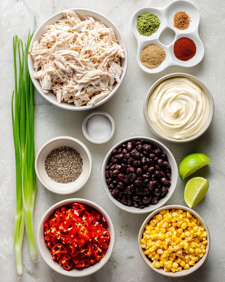 The image shows nine groups of ingredients arranged neatly on a white marbled surface. At the top left is a white bowl filled with shredded pale chicken, beside it to the right are two white dishes – one with a swirl of white sour cream and the other with six small piles of colorful spices including green, red, brown, and beige shades arranged in a circle. Below the chicken is a small white bowl with black pepper, next to it a small white container of salt. In the center is a white bowl of glossy black beans. At the bottom left is a white bowl filled with chopped red roasted peppers, and next to it is a white bowl of bright yellow grilled corn kernels. To the right of the beans is a small bowl with creamy mayonnaise and two halves of a bright green lime. Three green onions lie vertically on the left edge. Photo taken with an iphone --ar 4:5 --v 7
