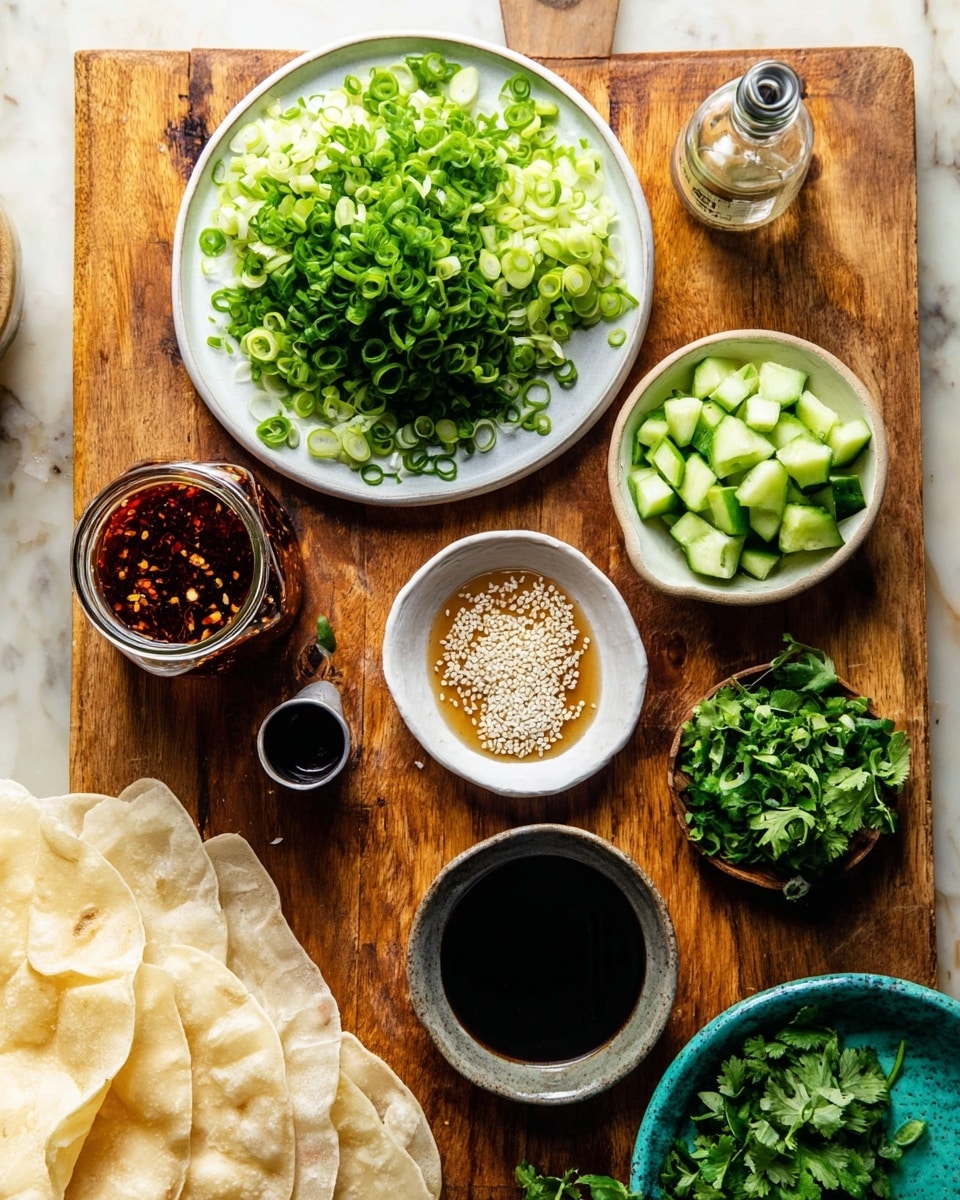 A wooden board sits on a white marbled surface with various small white bowls and dishes filled with different ingredients. At the top center, there is a white plate holding a heap of finely sliced green onions with a fresh, bright green color. To its right, there is a pile of small chopped green cucumbers with white flesh and dark green skin. Below the plate, a small white bowl contains a light brown sauce topped with white sesame seeds, and next to it, a small glass jar filled with a dark red chili oil. Nearby, a small metal cup holds a thick, dark soy sauce. On the left side of the wooden board, there are soft, round, folded flatbreads stacked loosely. At the lower right corner, part of a textured turquoise blue bowl is filled with chopped bright green cilantro. Photo taken with an iphone --ar 4:5 --v 7