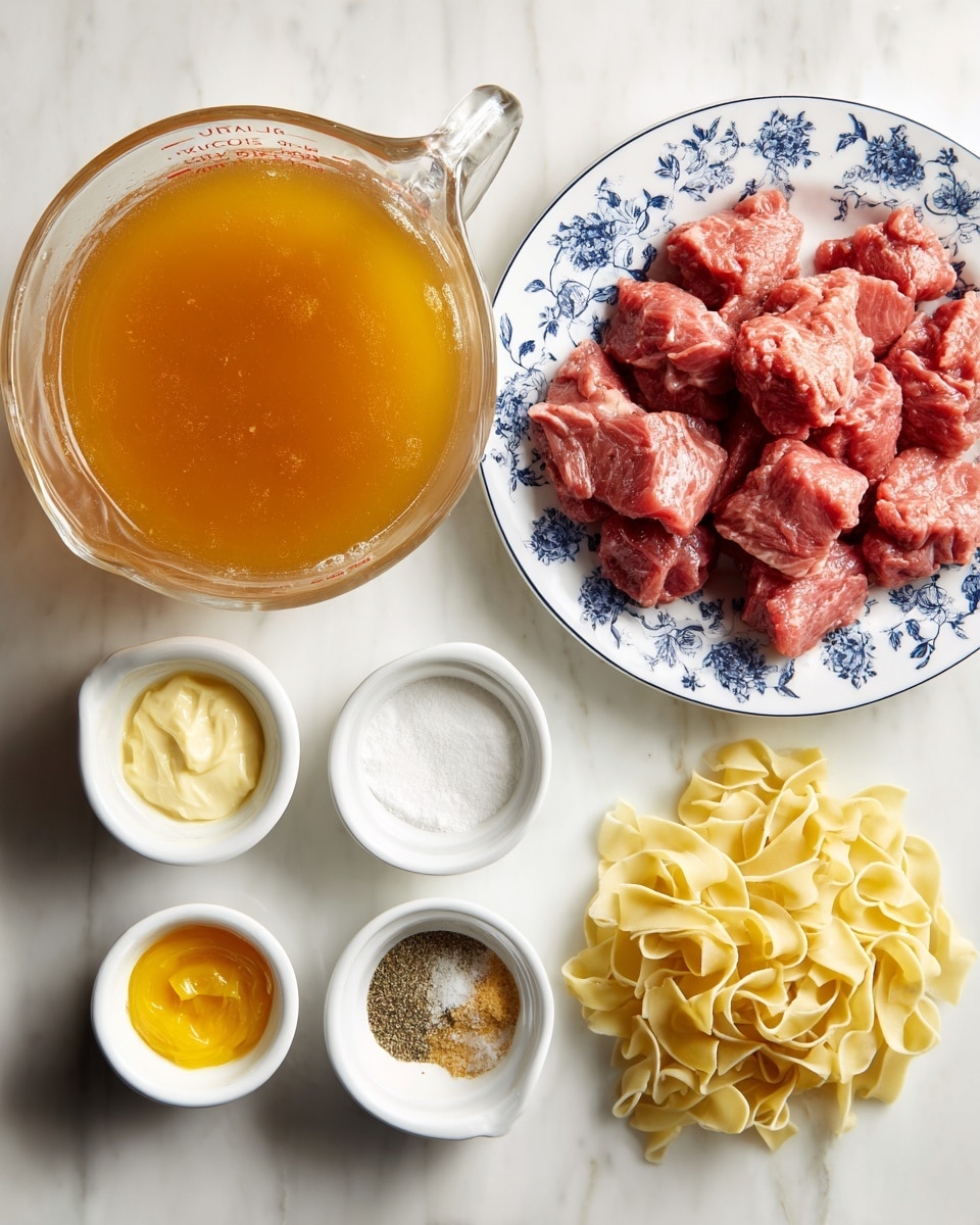 A clear glass measuring cup filled with amber-colored beef broth is placed on a white marbled surface. To the right, there is a white plate with a blue floral rim holding chunky, raw, red beef stew meat. Below the plate, six small white containers hold different ingredients: light yellow ranch seasoning mix, white heavy cream, bright yellow pepperoncinis, light brown dry brown gravy mix, and a small white dish containing a mix of beige garlic powder and black pepper. Next to the cream, a small pile of flat, light yellow Amish egg noodles rests directly on the white marbled surface. All items are arranged neatly and spaced out evenly. Photo taken with an iphone --ar 4:5 --v 7