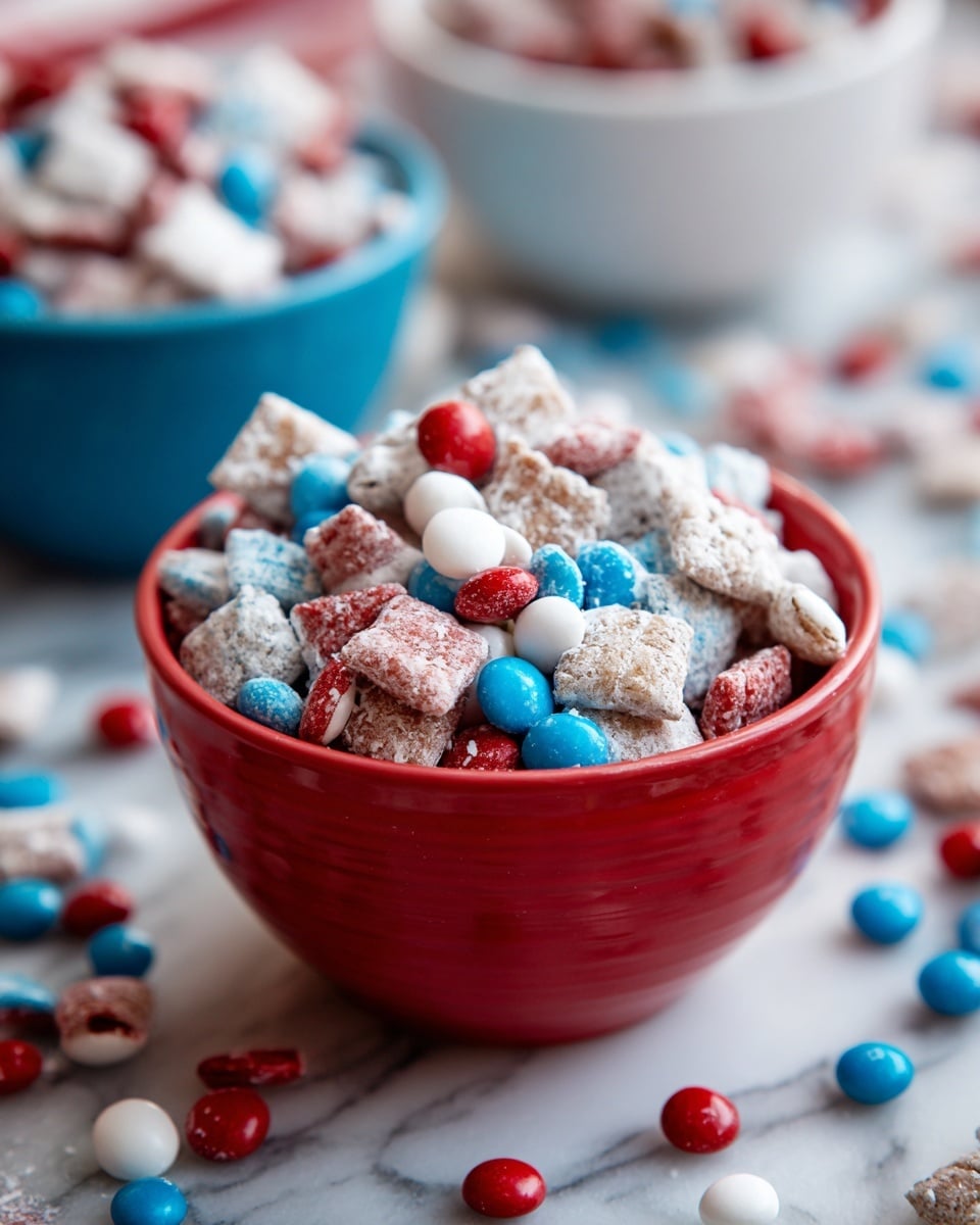 A close-up of a red cup filled with a snack mix made of small, square cereal pieces covered in white powder, mixed with round candy-coated chocolates in red, blue, and white colors. Behind, there is a blurred white bowl and a blue bowl, also filled with the same snack mix. The scene is on a white marbled surface with more loose red, blue, and white candy-coated chocolates scattered around. photo taken with an iphone --ar 4:5 --v 7