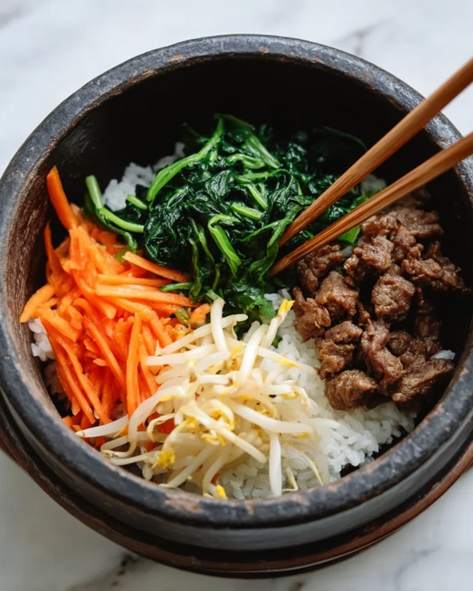 A dark brown stone bowl filled with four distinct layers of food arranged side by side on a bed of white rice at the bottom. On the left, there are bright orange carrot sticks that are thin and long. Next to them is a pile of cooked dark green spinach leaves with a slightly shiny texture. Beside the spinach are white and yellow bean sprouts with a soft, slightly translucent look. Finally, a cluster of cooked brown meat pieces is held by a pair of wooden chopsticks from the upper right. The bowl is placed on a white marbled surface. Photo taken with an iphone --ar 4:5 --v 7