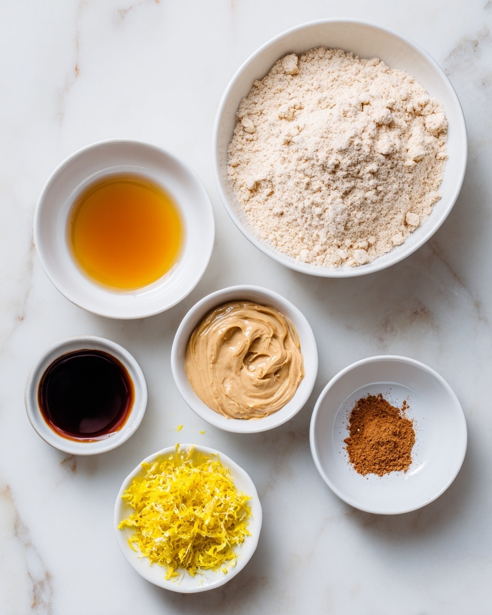 The image shows six white bowls placed on a white marbled surface. The largest bowl at the top right is filled with a light beige, powdery cassava flour. To the left of it, there is a small bowl filled with a clear, amber-colored maple syrup. Below the flour bowl, there is another small bowl with creamy, light brown nut butter. To the right of the nut butter, a small bowl contains bright yellow lemon zest, finely grated. At the bottom left, there's a bowl with dark brown vanilla liquid, and next to it on the right is a small bowl holding a few pinches of cinnamon powder, reddish-brown in color. Each bowl is neatly arranged and spaced with clear labels near them indicating the contents. photo taken with an iphone --ar 4:5 --v 7