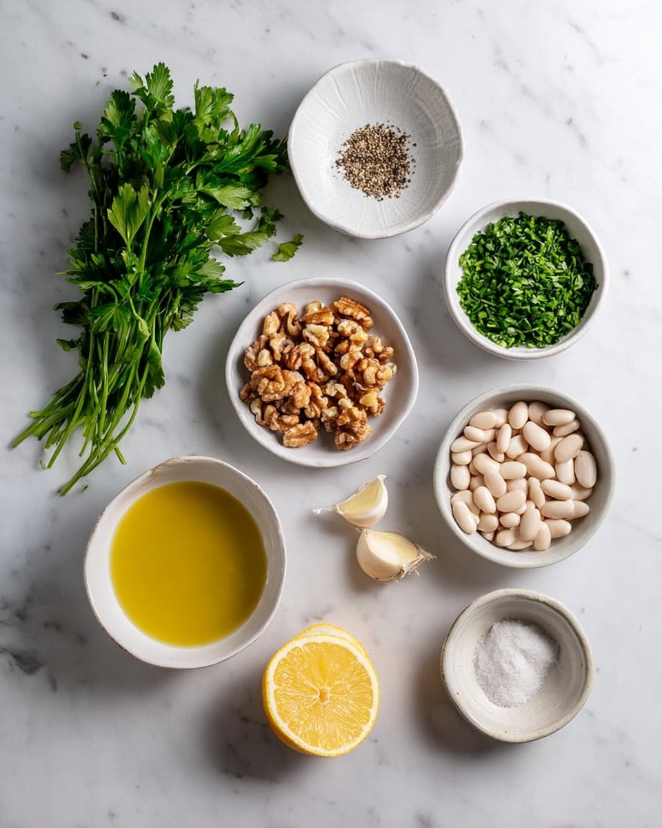 A top view shows ingredients neatly placed on a white marbled surface. There is fresh green parsley in a bunch on the left, and a white bowl with small black pepper next to it. A white bowl of chopped green chives is on the right top side. Below that, a clear bowl holds brown walnuts, while a white bowl filled with olive oil sits on the left. Centered below the pepper is a white bowl full of white beans. Nearby, half a lemon is cut and placed with the yellow side up. Small ceramic bowls hold salt and two cloves of peeled garlic. All items are arranged in a clean grid-like pattern with soft natural light. Photo taken with an iphone --ar 4:5 --v 7