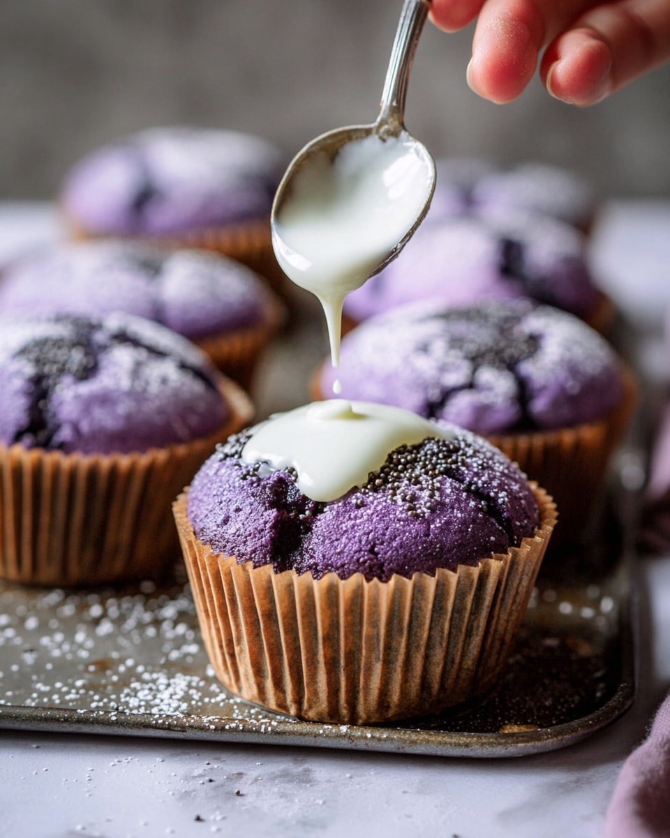 A close-up of a purple cupcake placed in a brown paper liner, sitting on a metal muffin tray on a white marbled surface. The cupcake has a rough, cracked top dusted with white powdered sugar and small dark sprinkles. A woman's hand holds a silver spoon above the cupcake, pouring white icing in a slow stream onto the center of the cupcake, creating a smooth contrast to the textured surface. In the background, there are more purple cupcakes with the same powdered sugar topping, slightly out of focus. Photo taken with an iphone --ar 4:5 --v 7