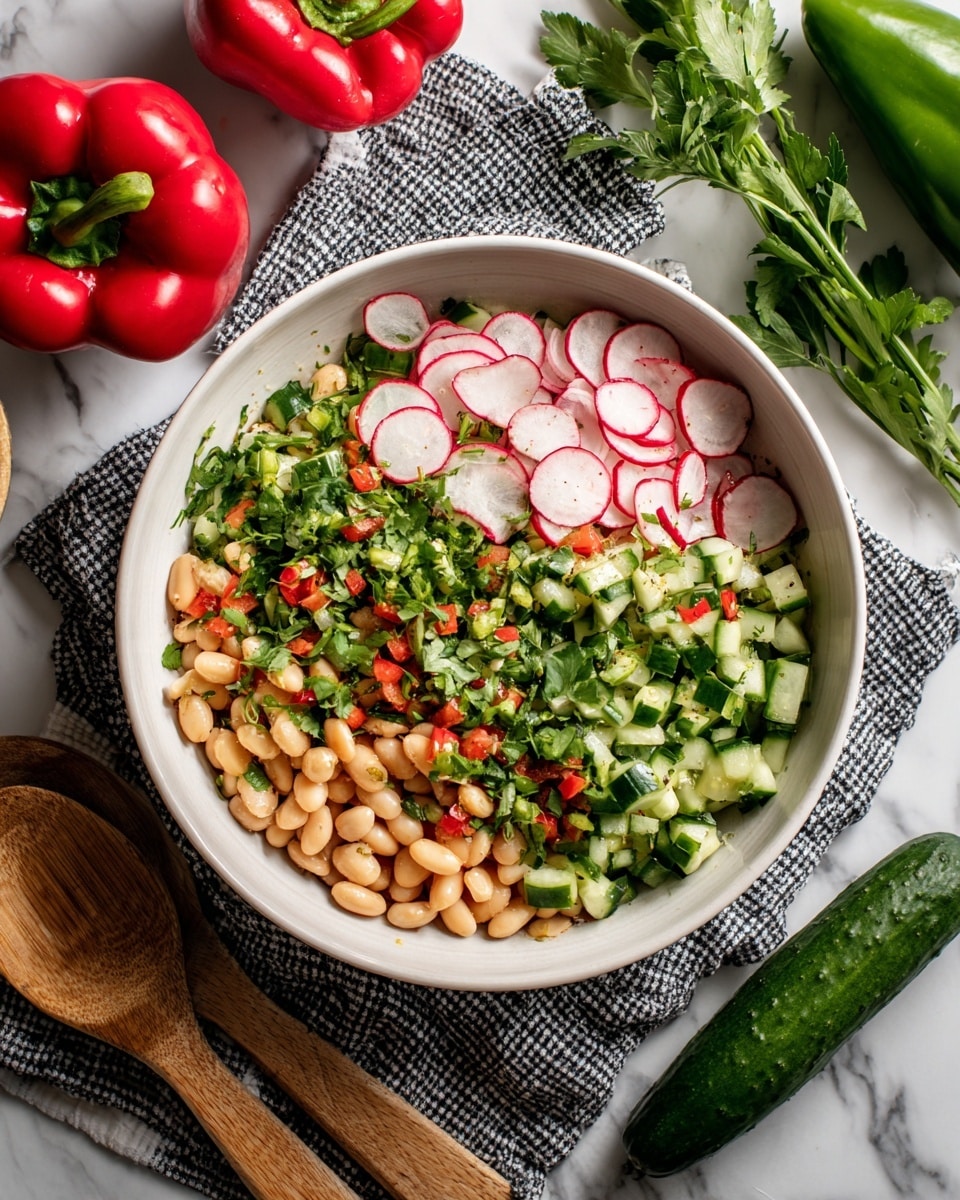 A white bowl filled with a fresh salad sits on a black and white checkered cloth over a white marbled surface. The salad has three main layers: the bottom layer is made up of small white beans, the middle layer consists of small green cucumber pieces and red bell pepper bits, sprinkled with chopped fresh green herbs like cilantro, and the top is dotted with thin slices of white and red radish. Around the bowl, there is a whole green bell pepper, a red bell pepper, and a dark green cucumber, along with wooden cooking utensils. Photo taken with an iphone --ar 4:5 --v 7