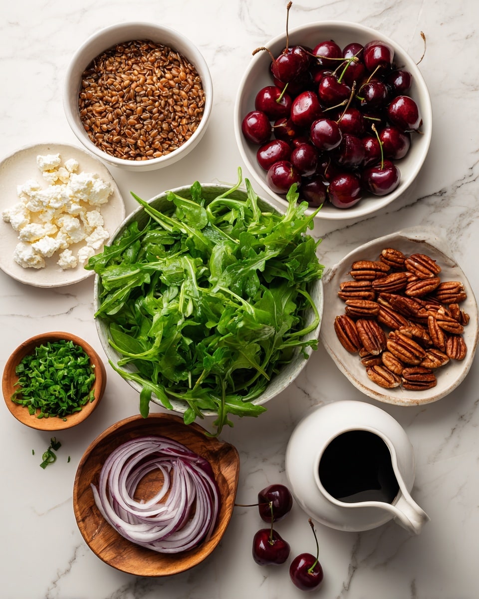 The image shows a collection of ingredients placed separately on a white marbled surface. At the center, a bowl is filled with fresh, bright green arugula leaves with a slightly crinkled texture. To the top left of it, there is a white bowl with cooked brown grains, slightly shiny and soft in texture. Below that, another white bowl holds crumbled white cheese with a rough texture. To the top right of the arugula, a white bowl is filled with deep red cherries, smooth and shiny with green stems, and two cherries are placed outside the bowl. Nearby, a small wooden bowl holds fresh green chopped herbs while another wooden bowl contains whole pecans with a bumpy texture, with some pecans scattered outside. A small white pitcher containing a dark liquid sits nearby on the marble surface, and to the bottom right, a white bowl holds thin, curved slices of red onion with white centers. All items are neatly arranged on the white marbled background. Photo taken with an iphone --ar 4:5 --v 7