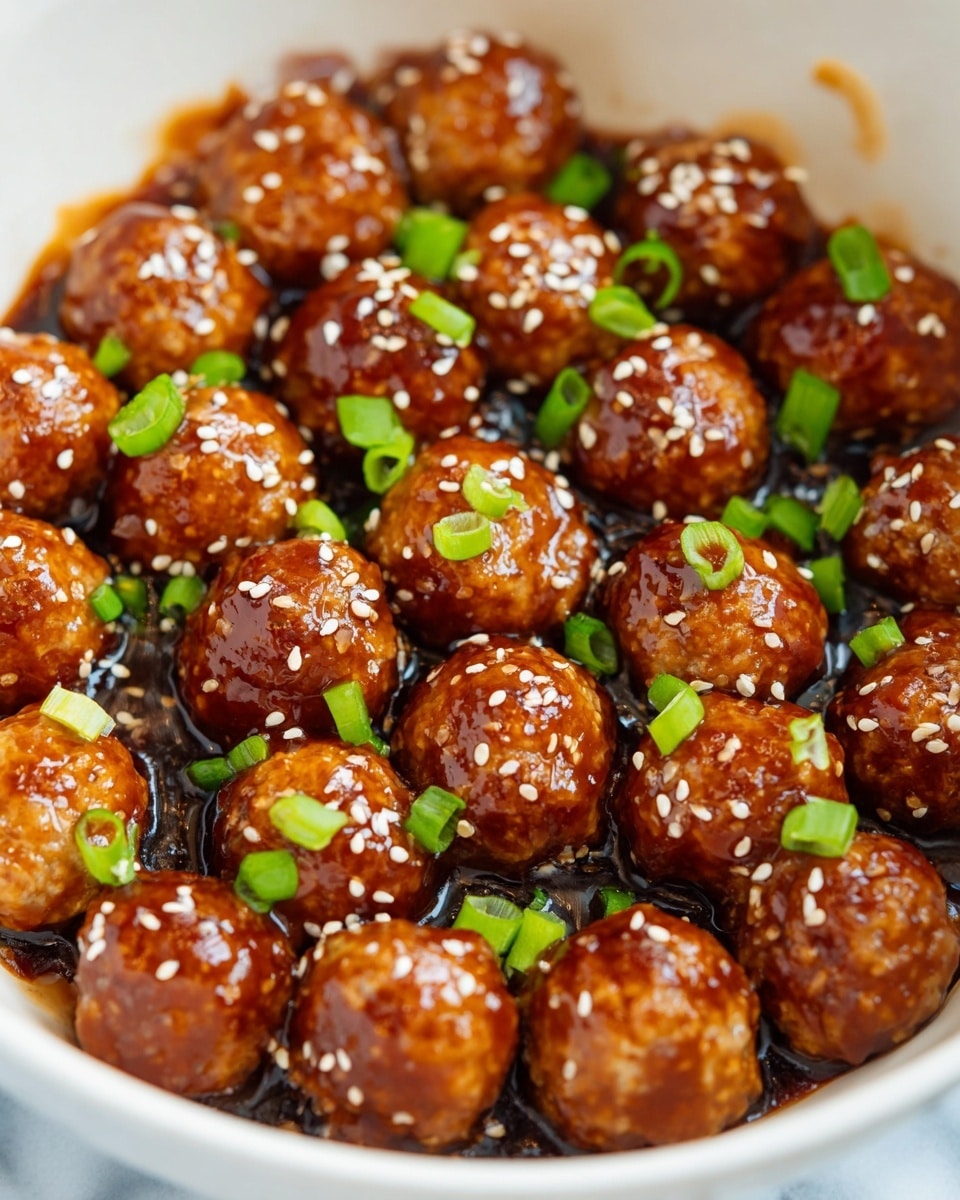 A white bowl on a white marbled surface holds around 20 meatballs covered in a thick, shiny brown sauce. Each meatball is topped with small white sesame seeds and surrounded by small pieces of bright green sliced green onions scattered around inside the bowl. The meatballs are tightly packed and have a smooth, glossy texture showing the sauce clearly coating them. photo taken with an iphone --ar 4:5 --v 7