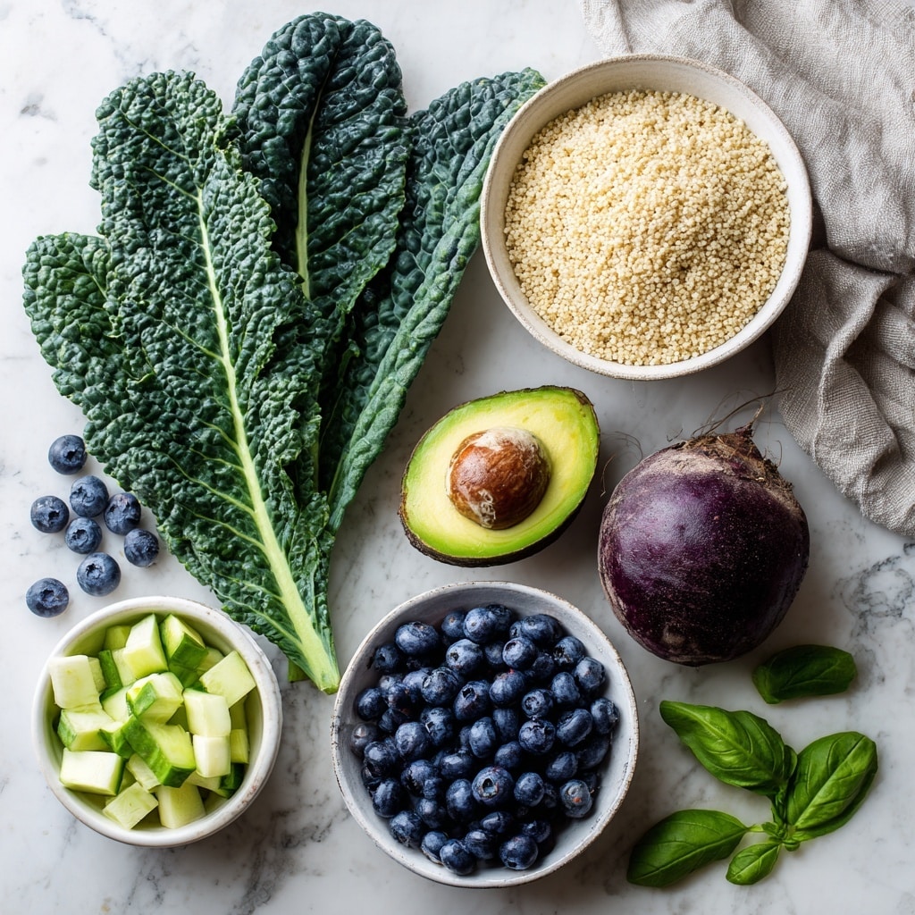 The image shows a flat lay of fresh healthy food items on a white marbled surface, including three large dark green kale leaves with a bumpy texture on the left, a white bowl full of cooked light beige quinoa on the top right, half an avocado with a green outer skin and smooth pale green inside placed near the center, a whole round beetroot with a rough dark purple and brown exterior below the avocado, a white bowl filled with many small, round, deep blue blueberries on the bottom left, and a white bowl containing diced pale green cucumber pieces on the bottom right. Scattered around are loose blueberries and bright green basil leaves, with a folded light grey cloth near the top right. Photo taken with an iphone --ar 4:5 --v 7