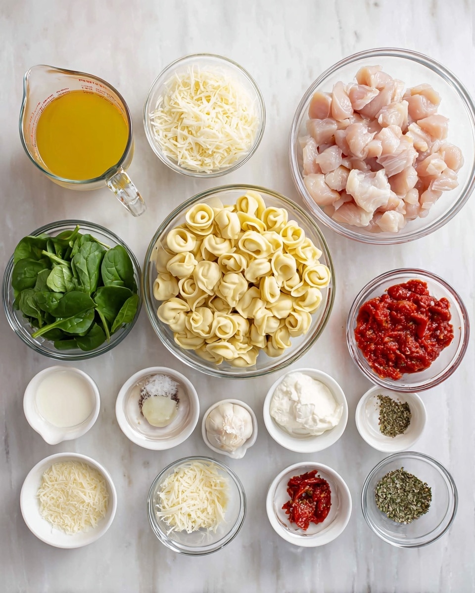 The image shows several clear glass bowls and white small dishes arranged on a white marbled surface, each holding different ingredients. The center bowl contains pale yellow tortellini pasta. To the right, a large bowl holds small pieces of raw light pink chicken. Above the tortellini are fresh green spinach leaves in a bowl. Below the spinach is a small bowl with grated white Parmesan cheese. To the right of the chicken is a bowl of red sun-dried tomatoes in oil. Several small white dishes hold dry herbs, spices, and salt, while a few other clear glass bowls contain minced garlic, white cream, shredded white mozzarella cheese, and corn starch. A small glass measuring cup filled with yellow broth is placed near the top left. The bright, clear setup features a variety of textures and colors, organized neatly for preparation. photo taken with an iphone --ar 4:5 --v 7