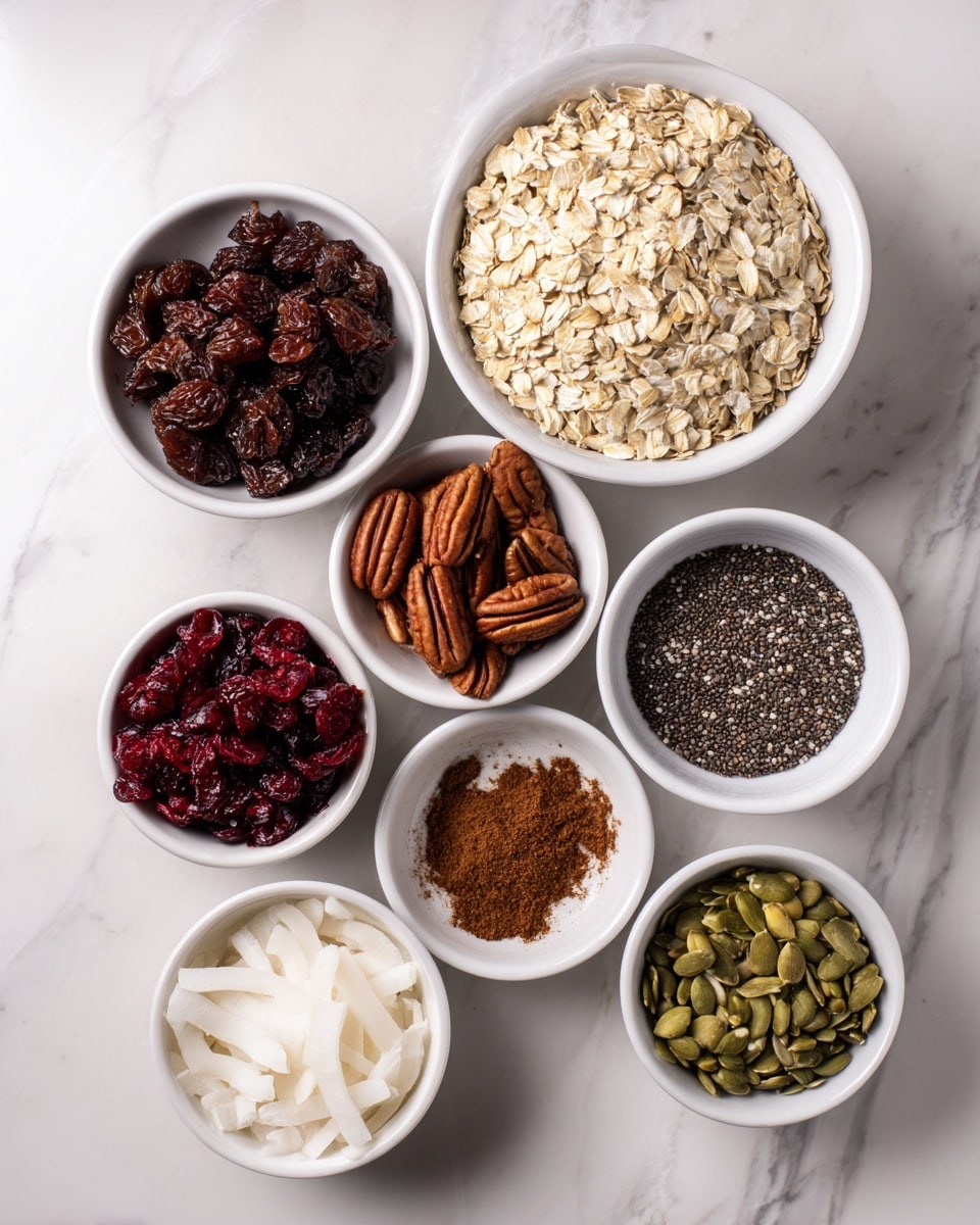 The image shows nine small white bowls arranged on a white marbled surface, each filled with different ingredients. The largest bowl at the top right is filled with light beige rolled oats with a rough, flaky texture. To its top left is a bowl with dark brown raisins, appearing wrinkled and shiny. Below the raisins is a bowl holding medium brown pecans, smooth and oval-shaped with deep ridges. Directly below the pecans is a bowl with deep red dried cranberries, glossy and wrinkled. To the right of cranberries is a bowl filled with tiny black chia seeds, smooth and round. Above the chia seeds is a small bowl with a brown cinnamon powder, fine and smooth. Next to it is a bowl with large white coconut flakes, flat and slightly curved. Below the coconut flakes is a bowl containing thin, pale almond slices. Lastly, at the bottom right is a bowl with green pumpkin seeds, smooth and flat. photo taken with an iphone --ar 4:5 --v 7