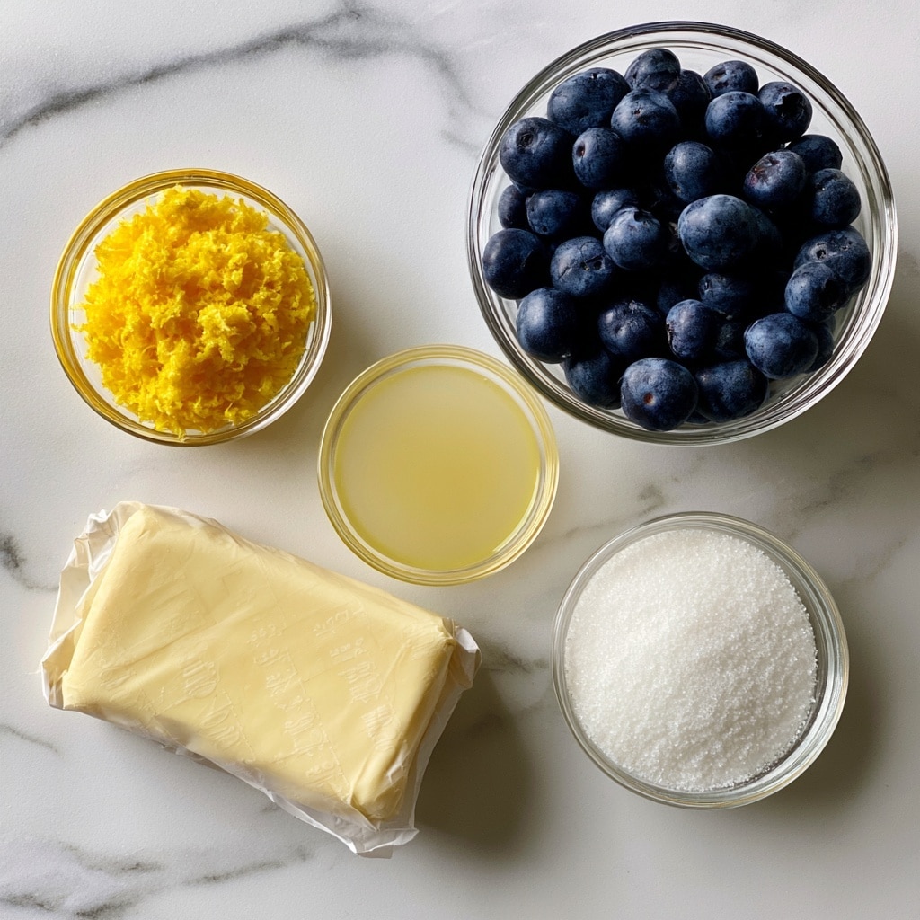 The image shows five ingredients placed on a white marbled surface. On the top right, a clear glass bowl is filled with fresh blueberries, dark blue and round. Below it, a smaller clear glass bowl holds white granulated sugar with a fine texture. To the top left, a small glass bowl contains bright yellow lemon zest, finely grated. Below the zest, a wrapped block of pale yellow butter is positioned, showing measurement marks on the wrapper. Between the butter and the blueberries, a small clear glass bowl contains a pale yellow liquid, lemon juice. Each ingredient is clearly visible and neatly arranged, with text labels indicating their names. Photo taken with an iphone --ar 4:5 --v 7