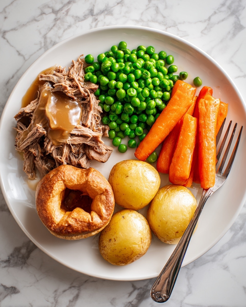 A white plate is neatly arranged with five layers of food: shredded brown meat with a light brown gravy on the left, bright green peas piled in the center-right, three long, orange carrot sticks lightly seasoned and stacked parallel on the right, three round, smooth yellow potatoes with some herbs near the bottom center, and a round, golden brown Yorkshire pudding with a bit of gravy on top near the bottom left. A silver fork lies on the right edge of the plate. The plate rests on a white marbled surface. Photo taken with an iphone --ar 4:5 --v 7