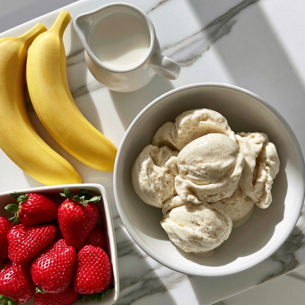 A white bowl filled with several scoops of creamy vanilla bean ice cream showing small vanilla specks. To the left, two bright yellow bananas rest on a white marbled surface. Above the bananas, a small white pitcher holds whole milk with a smooth surface. Below the bananas, a square white bowl is full of fresh, bright red strawberries with green leafy tops. The scene is set on a white marbled background with soft natural light. photo taken with an iphone --ar 4:5 --v 7