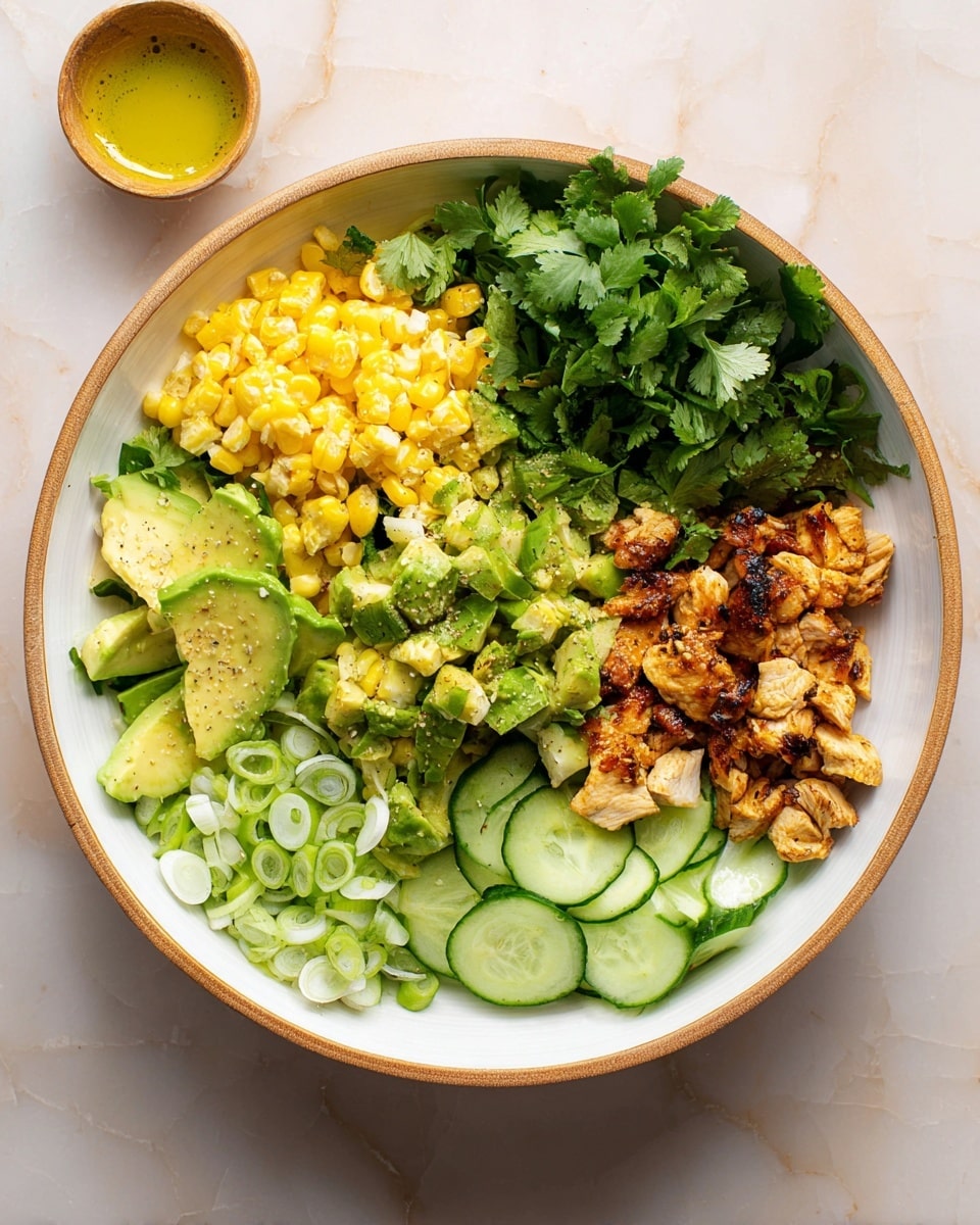 A large white bowl with a wooden rim sits on a white marbled surface, filled with layers of food arranged in sections. At the top left, there are bright yellow grilled corn pieces with slight char marks. To the right of the corn, fresh, dark green cilantro leaves cover the middle section. Below the cilantro, there are light green avocado chunks mixed with cooked, browned diced chicken pieces. On the far right, a neat stack of thin, pale green cucumber slices is visible. The bottom left corner holds sliced green onions, showing their light and dark green colors. The whole bowl is fresh and colorful, with varied textures and natural light shining clear on the ingredients. Photo taken with an iphone --ar 4:5 --v 7