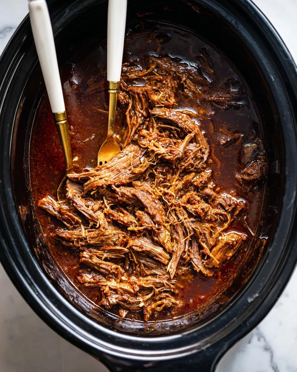 Inside a black slow cooker, there is one thick layer of shredded brown meat soaked in dark brown sauce with a glossy texture, with some pieces showing fibrous strands. Two forks with white and gold handles are placed on the left side, one fork resting in the meat while the other is on the edge of the cooker. The background is a white marbled surface visible at the corners. Photo taken with an iphone --ar 4:5 --v 7