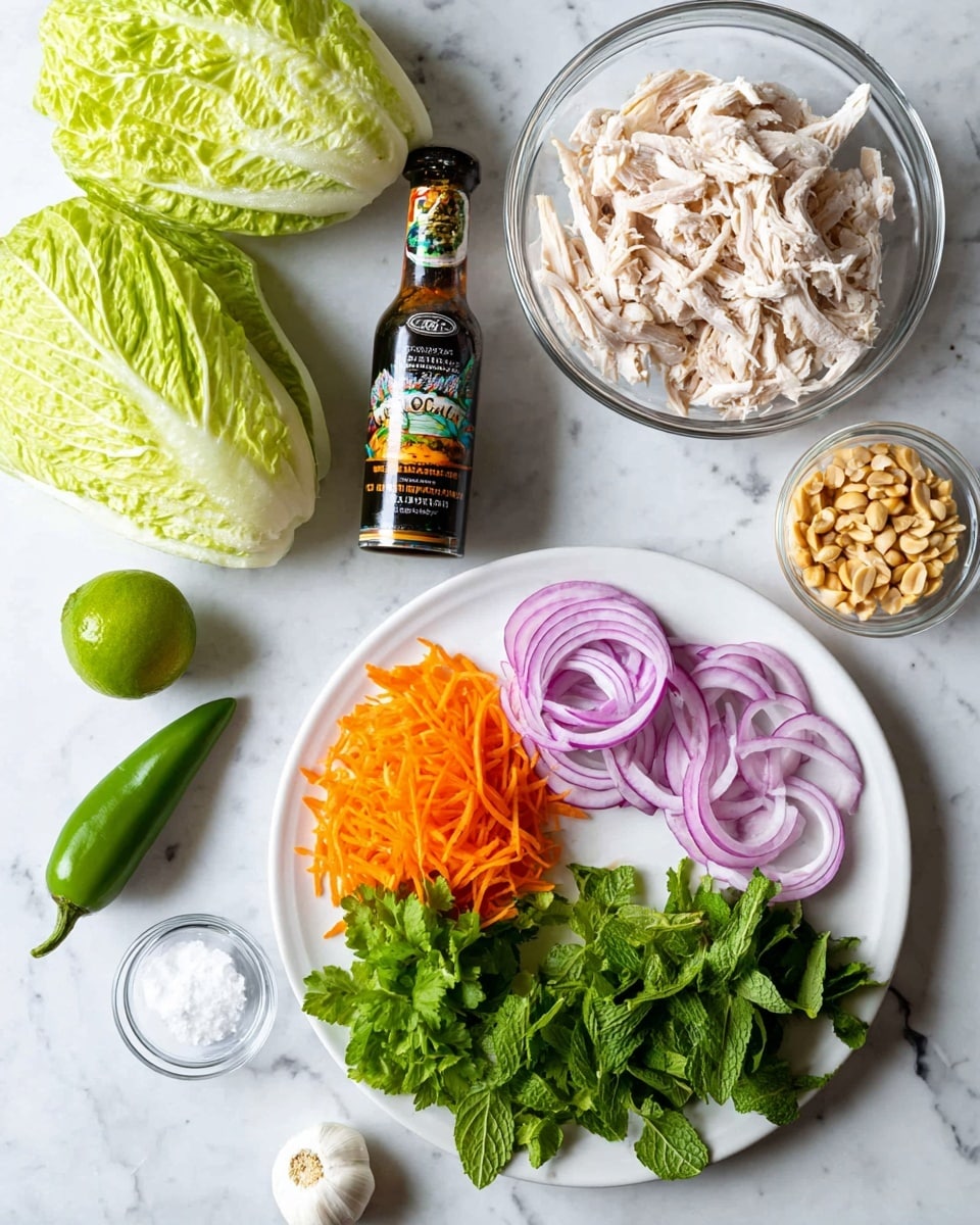 The image shows fresh cooking ingredients spread on a white marbled surface. On a white plate, there are neatly arranged layers: thinly sliced red onion rings on the left, bright shredded orange carrots in the middle, and fresh green herbs including cilantro and mint on the bottom right. To the right of the plate, a clear glass bowl filled with shredded white chicken is placed. Above the bowl, there are two large, light green napa cabbage leaves with detailed veins. At the top left, a bottle of dark fish sauce with a colorful label stands upright. Scattered around the plate and bowl are a whole green chili, a clove of garlic, a whole lime, and two small clear bowls—one holding chopped peanuts and the other filled with coarse white salt. photo taken with an iphone --ar 4:5 --v 7