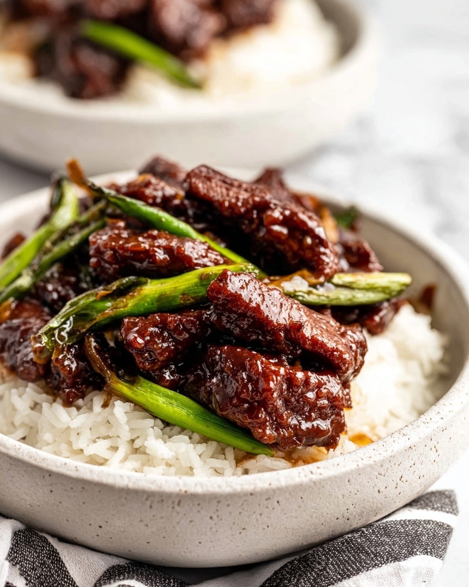 A round white plate filled with two layers: the first layer is fluffy white rice spread evenly; on top, there is a thick layer of dark brown beef strips coated in a shiny sauce, mixed with bright green pieces of cooked spring onions. The beef looks tender and moist, with visible garlic bits scattered throughout. The plate is placed on a surface with a white marbled texture, beside a pair of wooden chopsticks and a striped cloth. Photo taken with an iphone --ar 4:5 --v 7