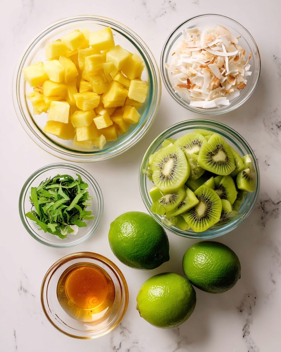A top view of a white marbled surface with six clear glass bowls and two whole limes arranged neatly. The largest bowl on the left holds bright yellow pineapple cubes. To the right of it, a slightly smaller bowl is filled with sliced kiwi pieces showing their green color and black seeds. Above the kiwi bowl, a small bowl contains toasted coconut flakes, white and light brown in color. Below the coconut bowl, there is a small bowl of shredded fresh green mint leaves. Next to the mint, another small bowl holds golden honey. Two whole green limes sit side by side on the right edge of the white marbled surface. Each bowl is clear glass, showing the fresh, colorful fruit and other ingredients inside. photo taken with an iphone --ar 4:5 --v 7