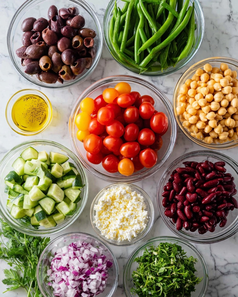 The image shows several clear glass bowls arranged on a white marbled surface, each bowl filled with different fresh ingredients. From top to bottom there are dark purple olives, green cut green beans, a large bowl of halved red cherry tomatoes in the center, yellow chickpeas, chopped green cucumbers, deep red kidney beans, chopped red onions, crumbled white cheese, and a small bowl of yellow dressing with pepper on top. There are also some fresh green herbs placed near the olives and tomatoes. The colors are bright and fresh, with the bowls arranged closely together. Photo taken with an iphone --ar 4:5 --v 7
