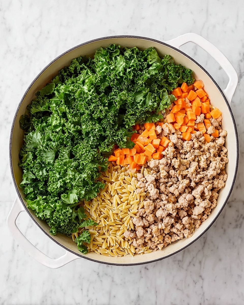 A large white pan is filled with three clear sections of food: on the left side, there is a pile of fresh, bright green chopped kale with curly leaves; in the middle, a layer of small, light orange chopped carrots mixed with golden orzo pasta; and on the right side, a layer of cooked ground meat with a light brown color and crumbly texture. The entire scene is set on a white marbled surface. photo taken with an iphone --ar 4:5 --v 7